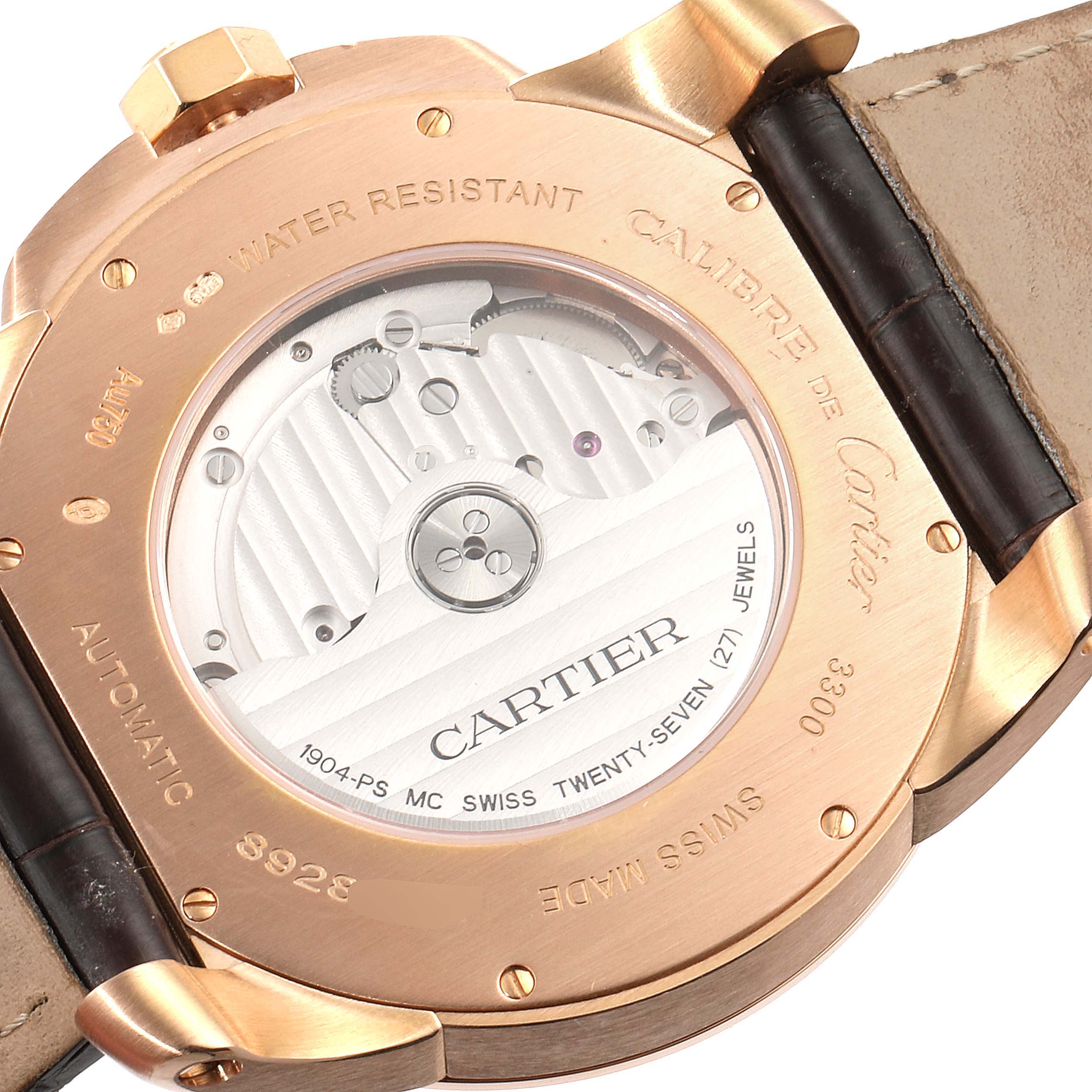 The image shows the back view of the Calibre de Cartier watch by Cartier, highlighting the automatic movement and engraving details.