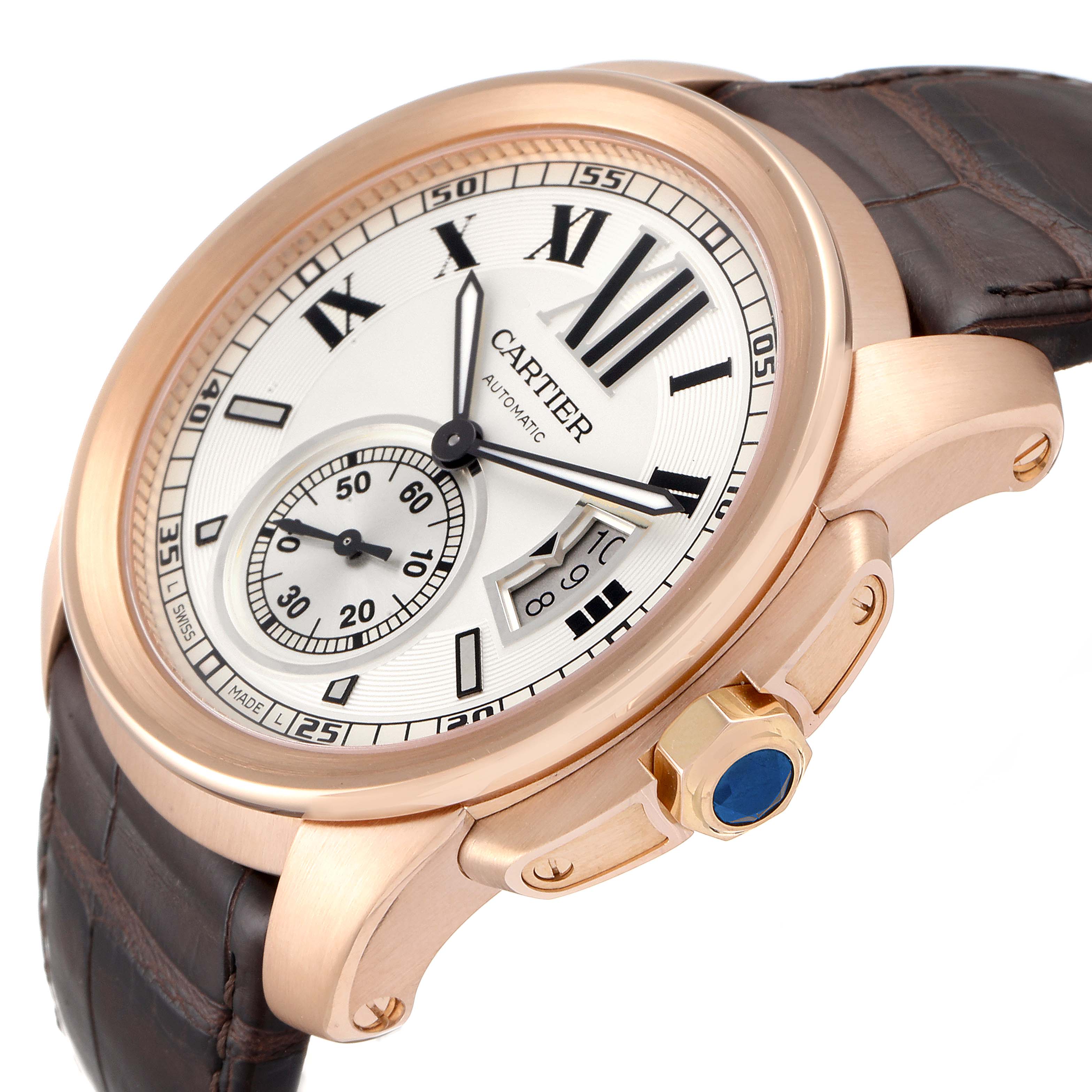 The image shows a close-up angle of the Calibre de Cartier watch by Cartier, highlighting the dial, case, leather strap, and crown.