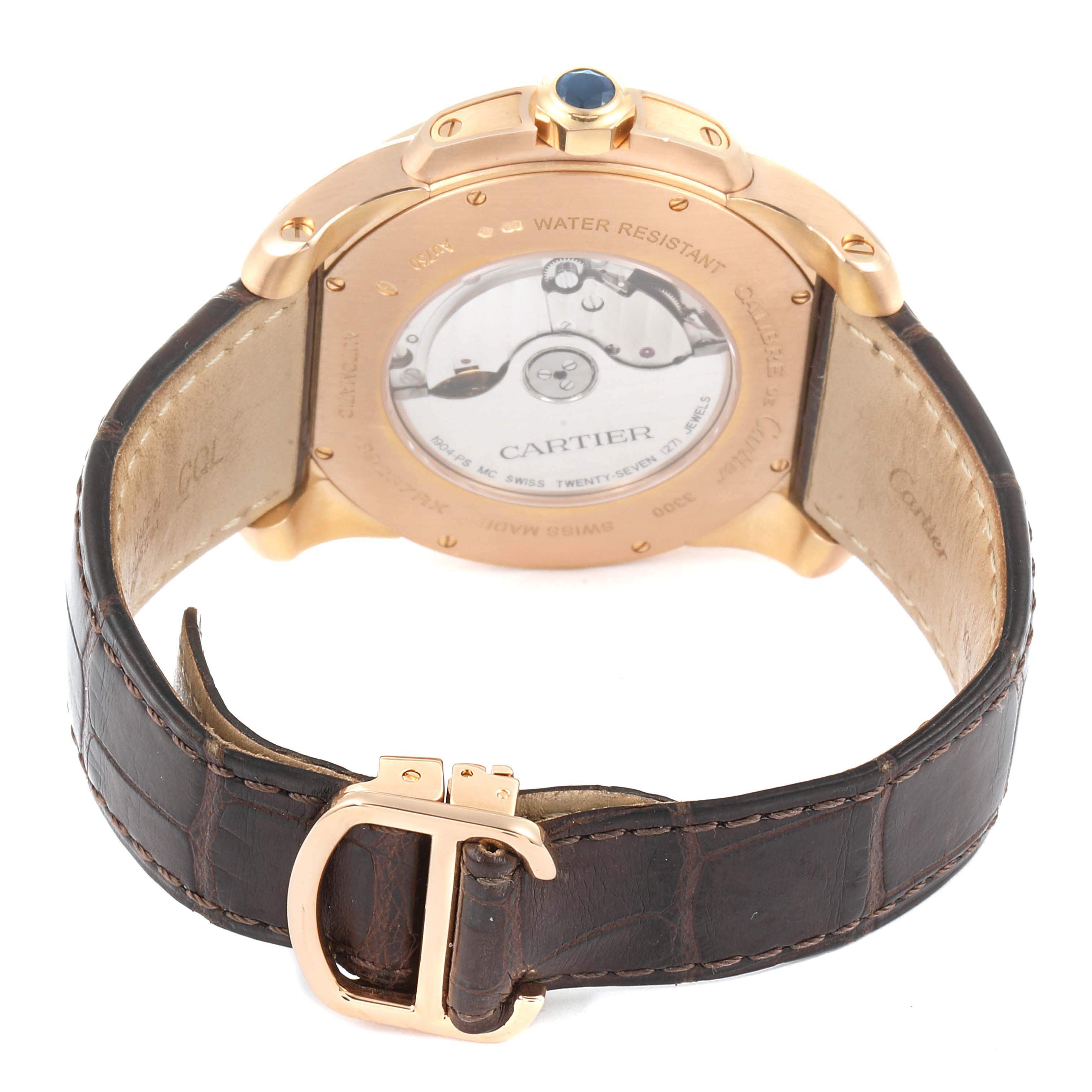 The image shows the back view of a Calibre de Cartier watch by Cartier, revealing the movement and leather strap with a deployment clasp.