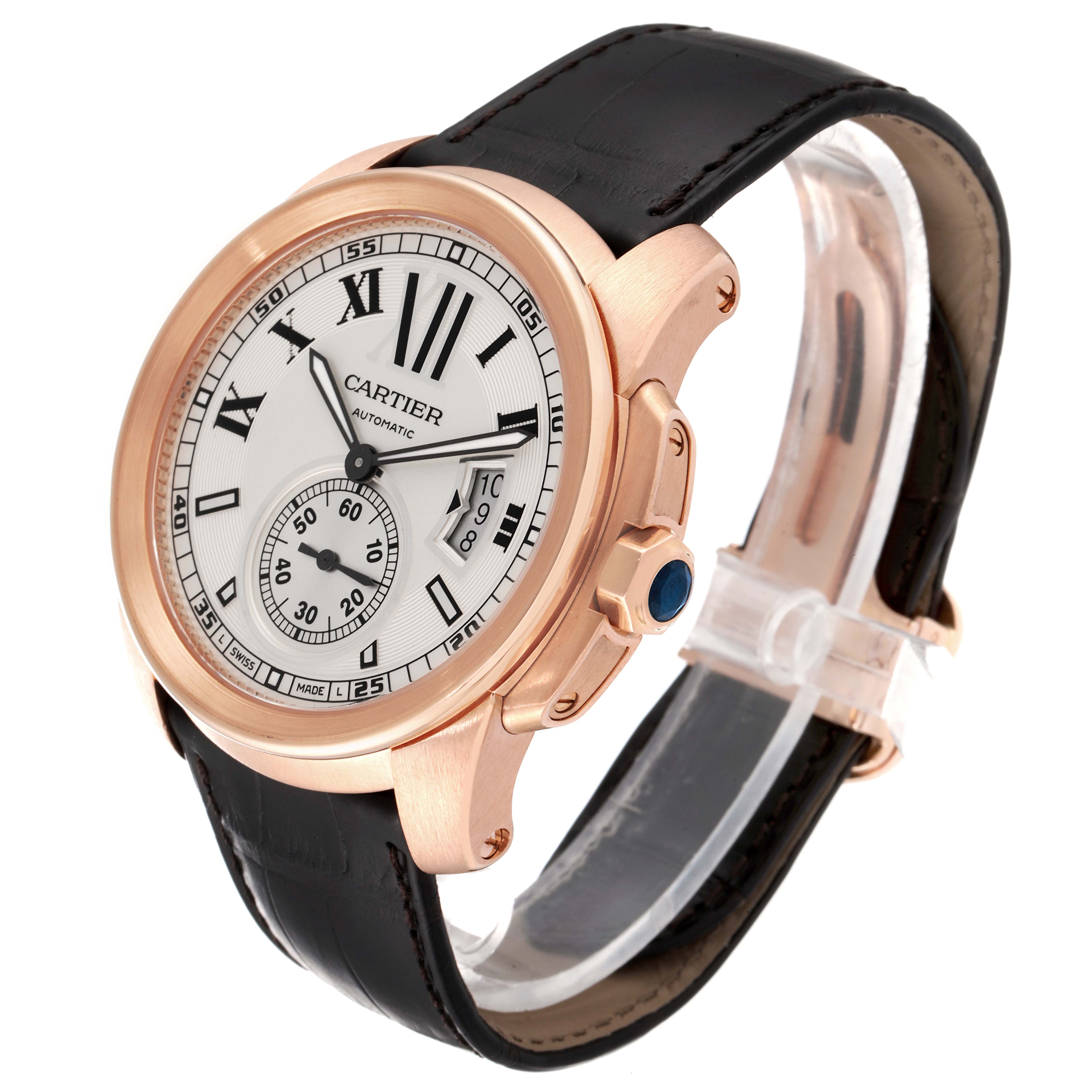The image shows a Calibre de Cartier watch by Cartier at a slight angle, displaying the face, bezel, crown, and leather strap.