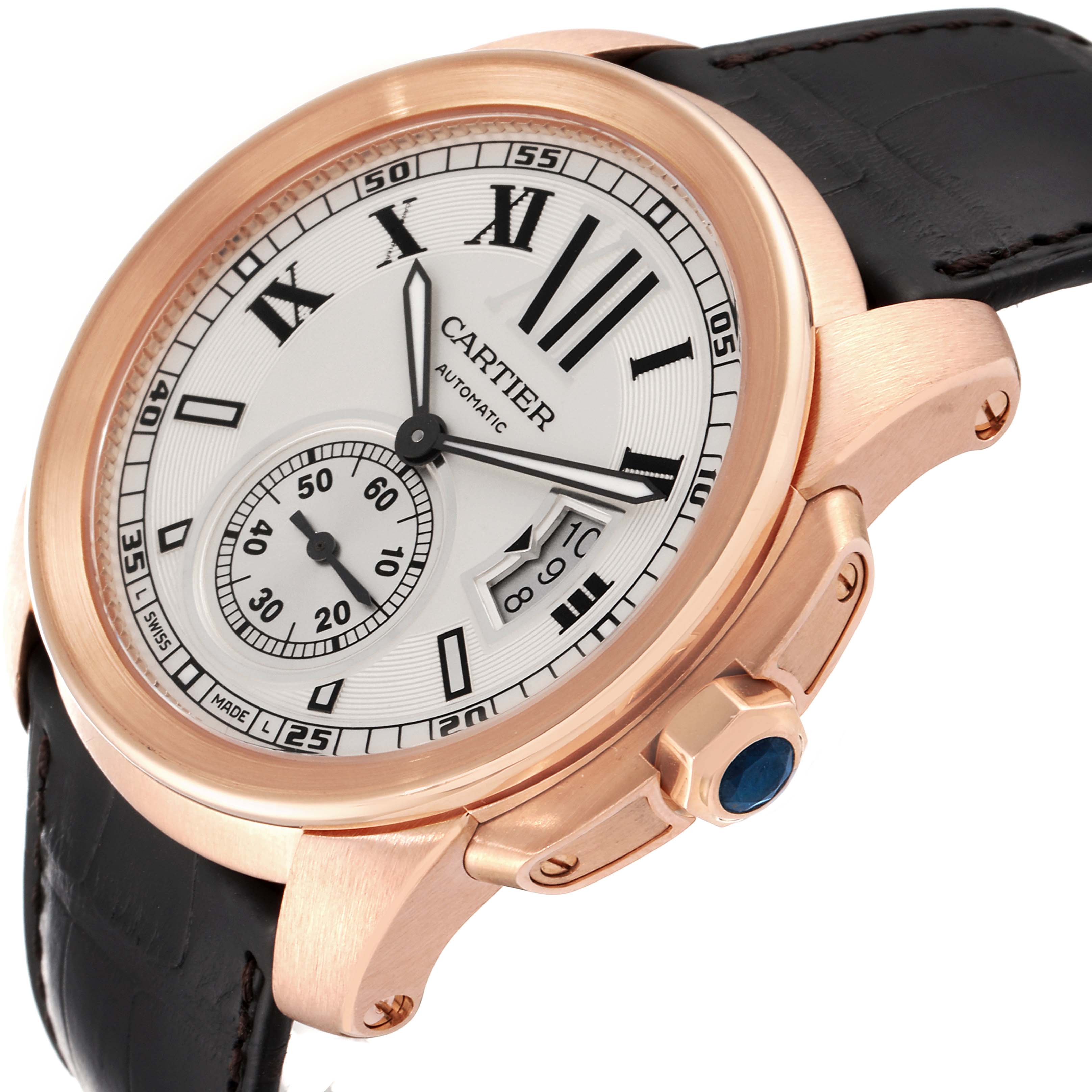 The image shows a close-up, angled view of the Calibre de Cartier watch by Cartier, highlighting the dial, case, and leather strap.