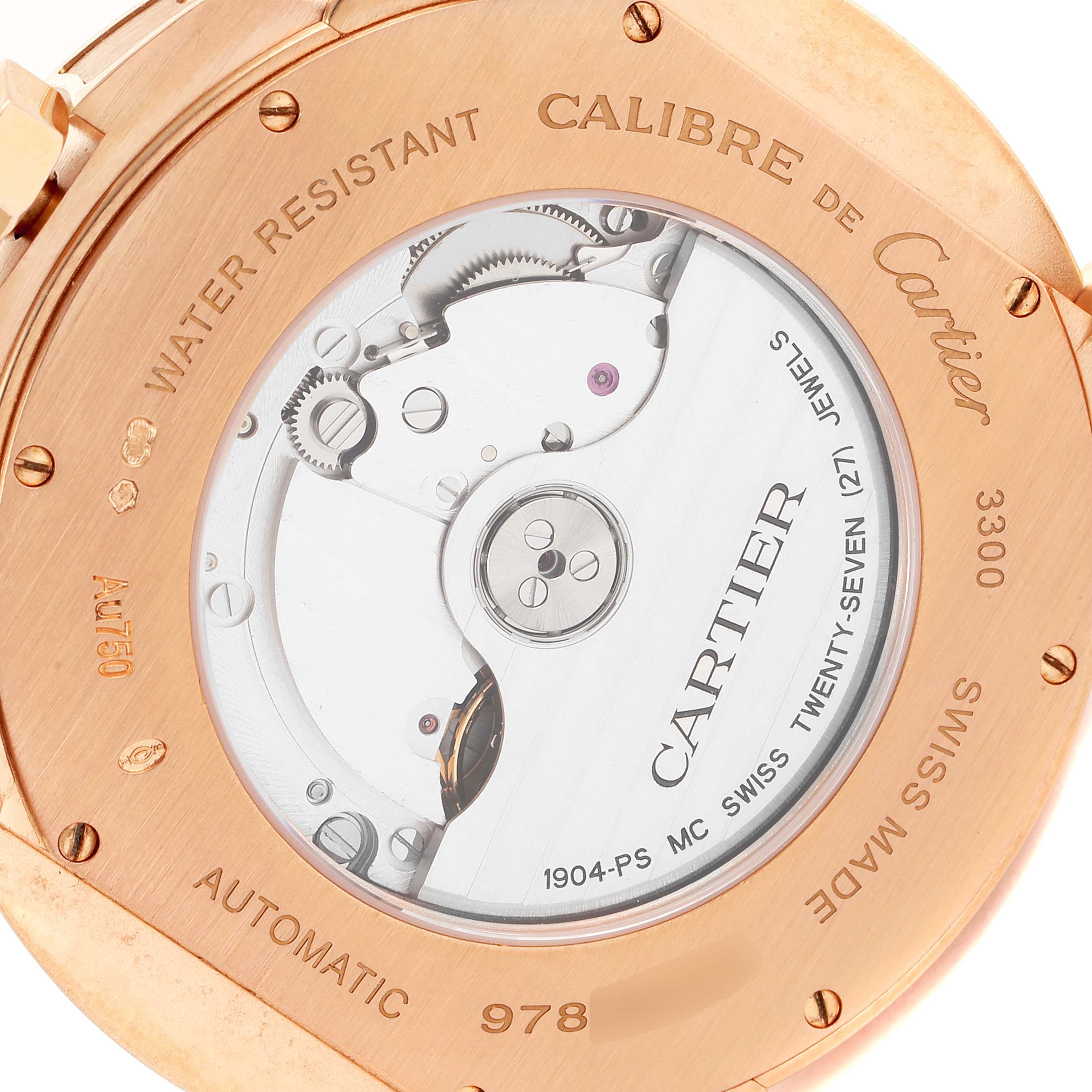 The image shows the back view of a Calibre de Cartier watch by Cartier, displaying the automatic movement and engraved details.