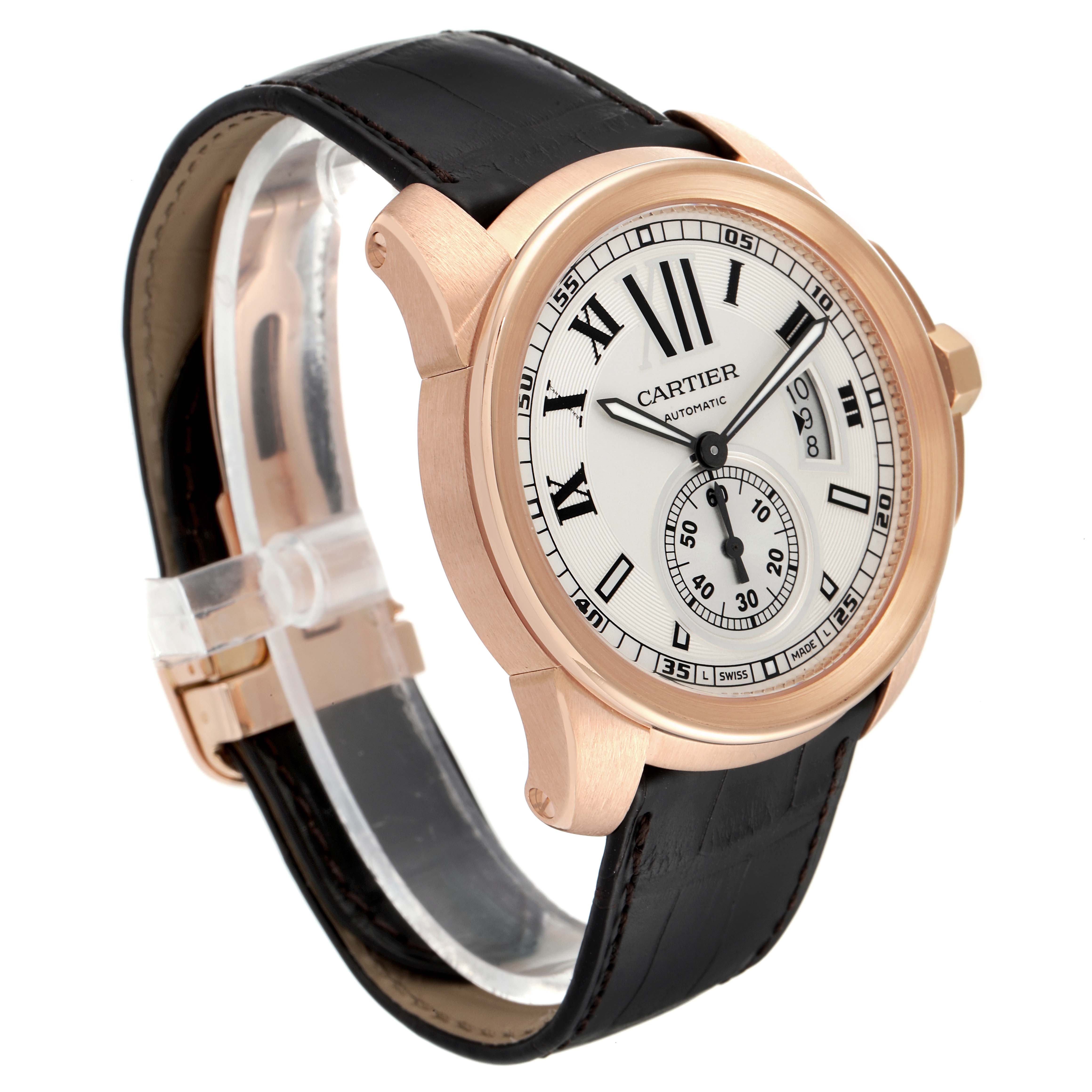 The image shows a Calibre de Cartier watch by Cartier from a front-side angle, highlighting the dial, case, crown, and black leather strap.