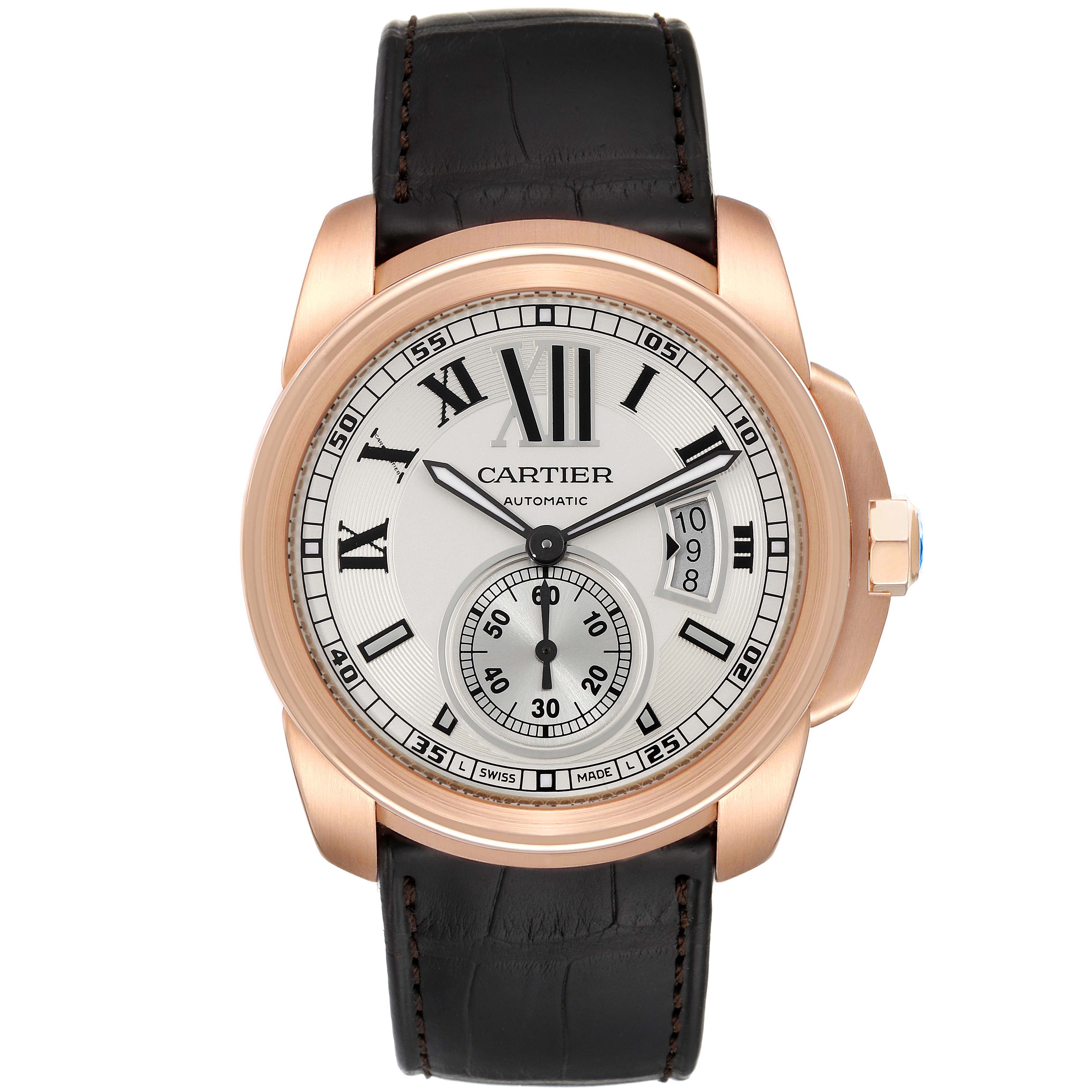 The image shows a front view of the Calibre de Cartier watch by Cartier, featuring its dial, case, crown, and leather strap.