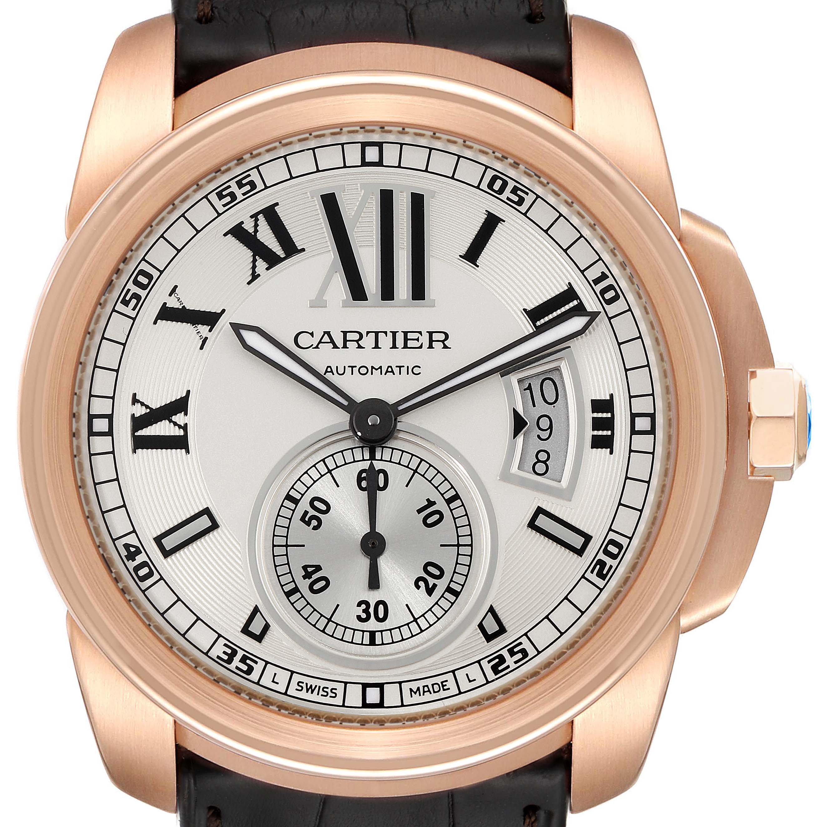 The image shows a frontal view of the Calibre de Cartier watch by Cartier, highlighting the dial, hands, and date display.