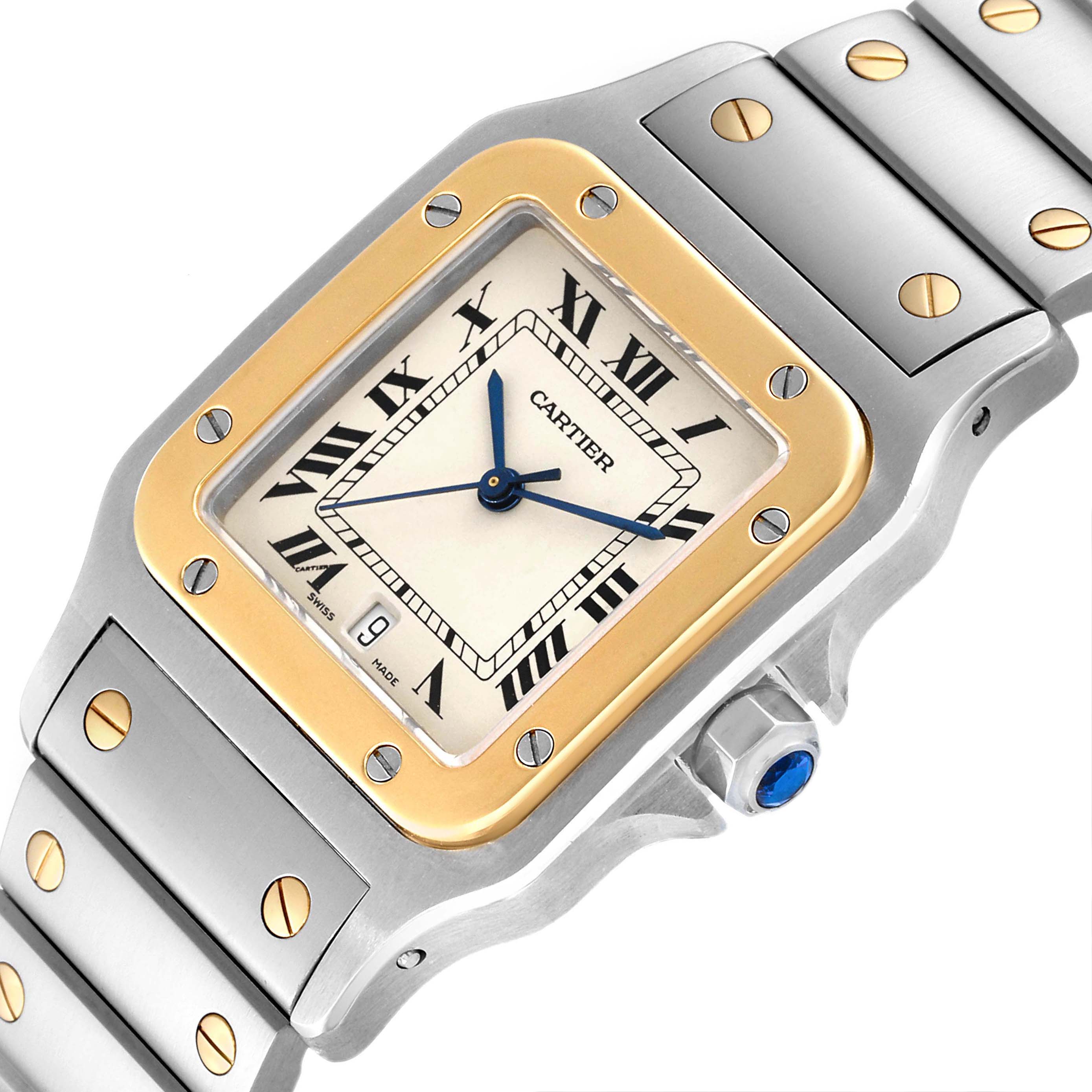 A close-up view of the Cartier Santos 1566 Men
s Steel and Gold (two tone) Silver Dial 1566 Men
s Steel and Gold (two tone) Silver Dial watch showing the dial, bezel, bracelet, and crown with a blue gem.