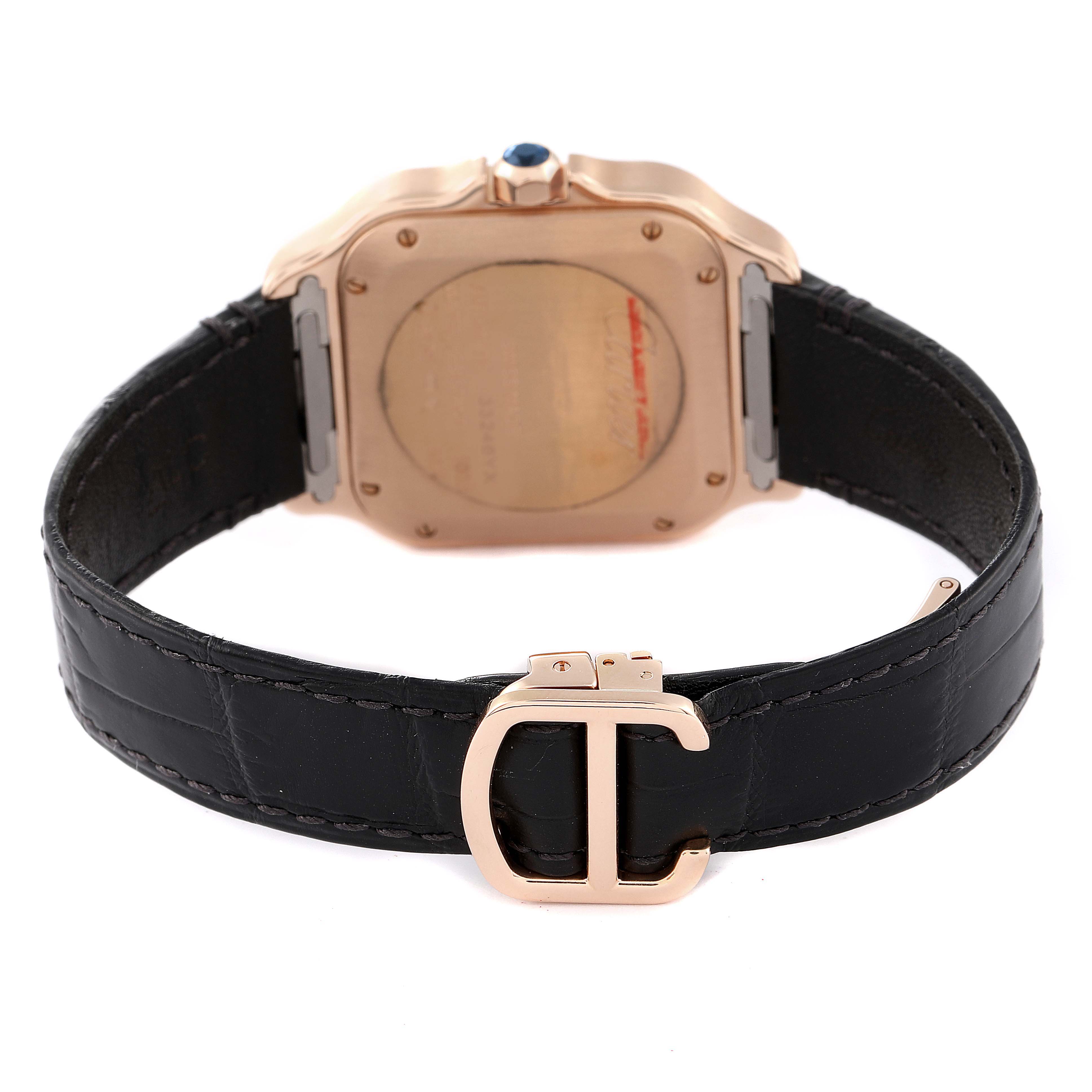 The image shows the backside of a Cartier Santos WJSA0007 Men
s Rose Gold Silver Dial WJSA0007 Men
s Rose Gold Silver Dial watch and its black leather strap with a rose gold buckle.