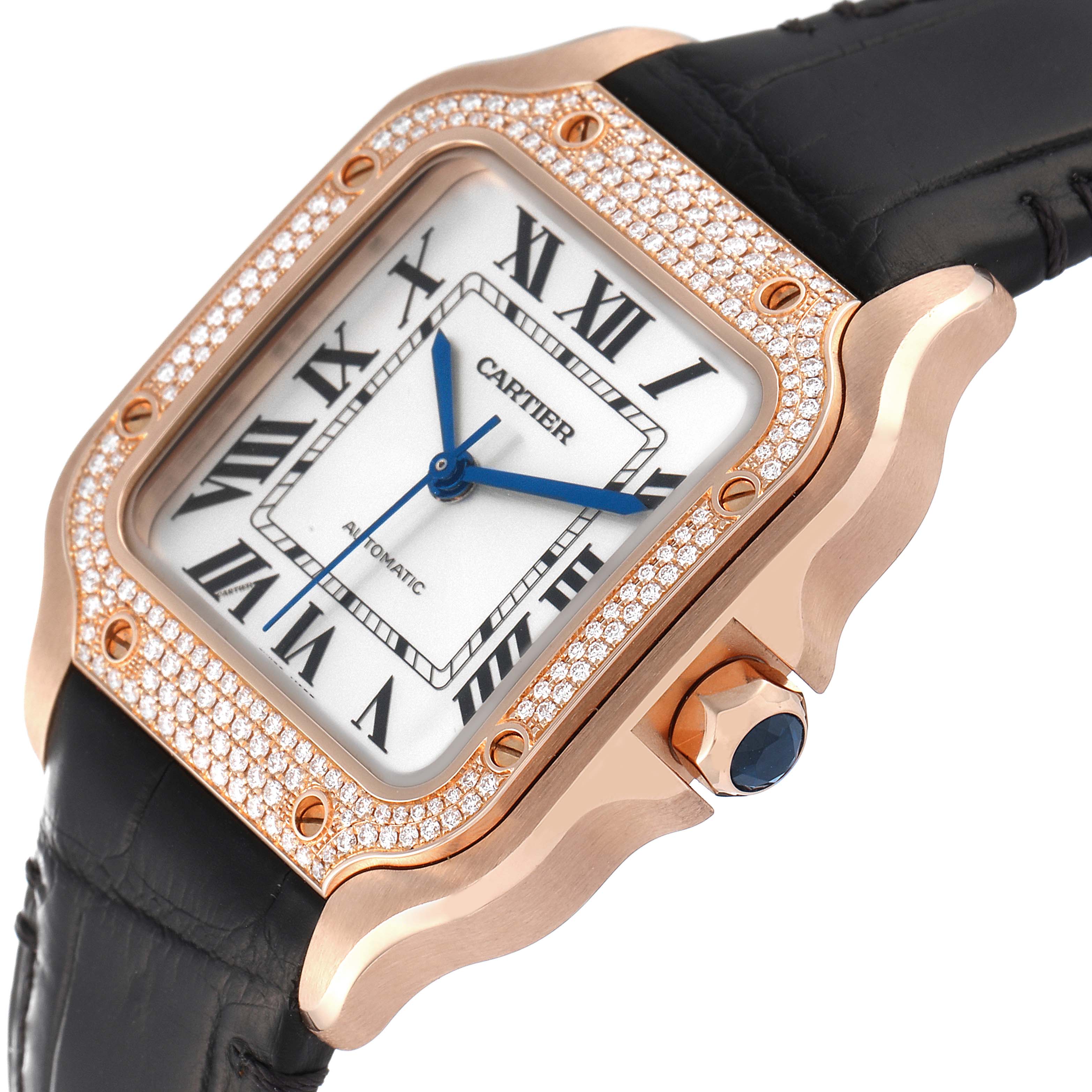 The Cartier Santos WJSA0007 Men
s Rose Gold Silver Dial WJSA0007 Men
s Rose Gold Silver Dial watch is shown from an angle highlighting its diamond-studded bezel, rose gold case, and black leather strap.