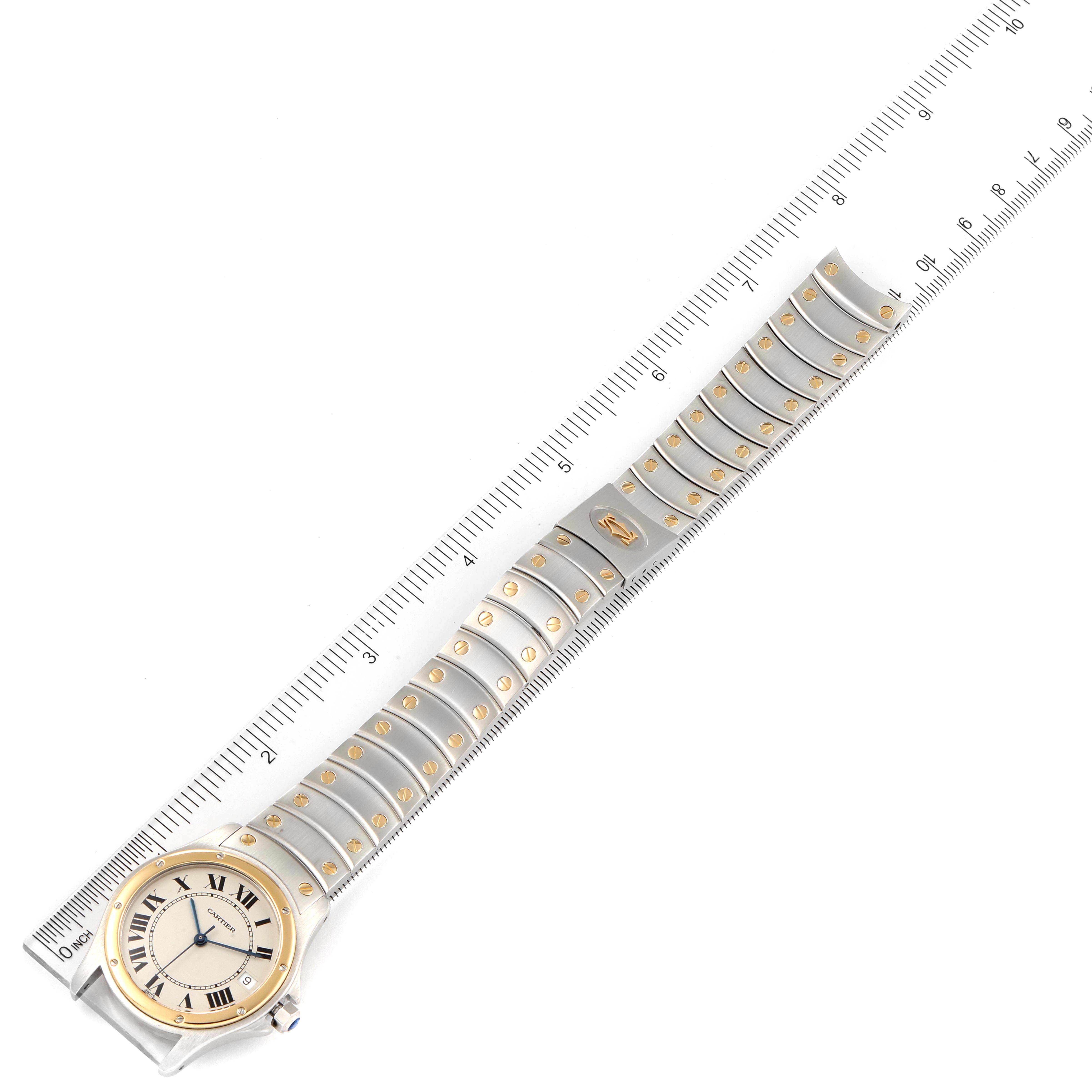 The image shows a top-down view of a Cartier Ronde W20028G1 Men
s Steel and Gold (two tone) Silver Dial W20028G1 Men
s Steel and Gold (two tone) Silver Dial model watch with its full band extended alongside a ruler.