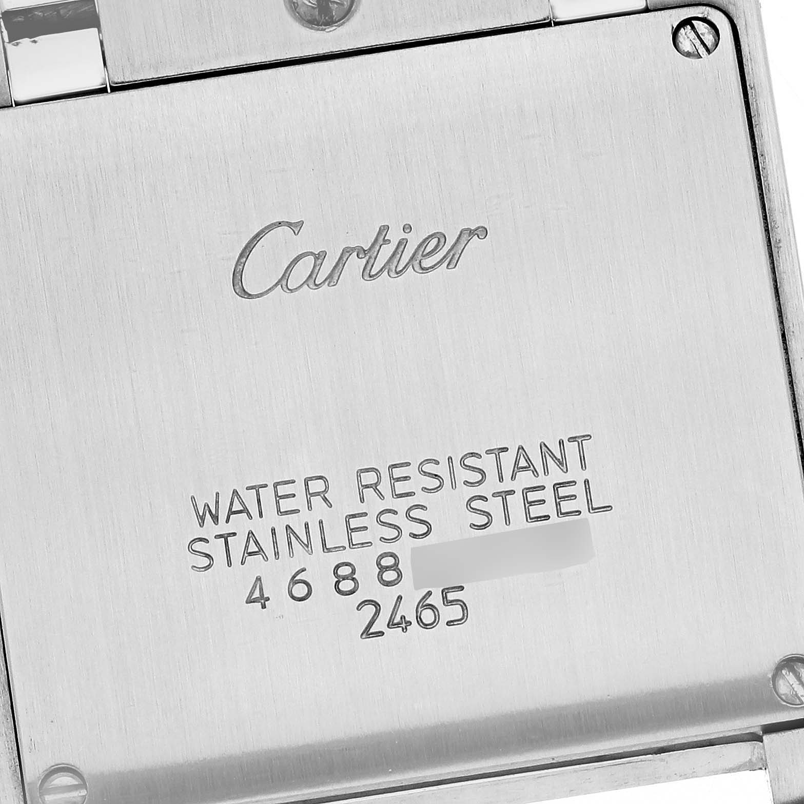 The image shows the back case of a Cartier Tank Française watch with its water resistance and stainless steel markings.