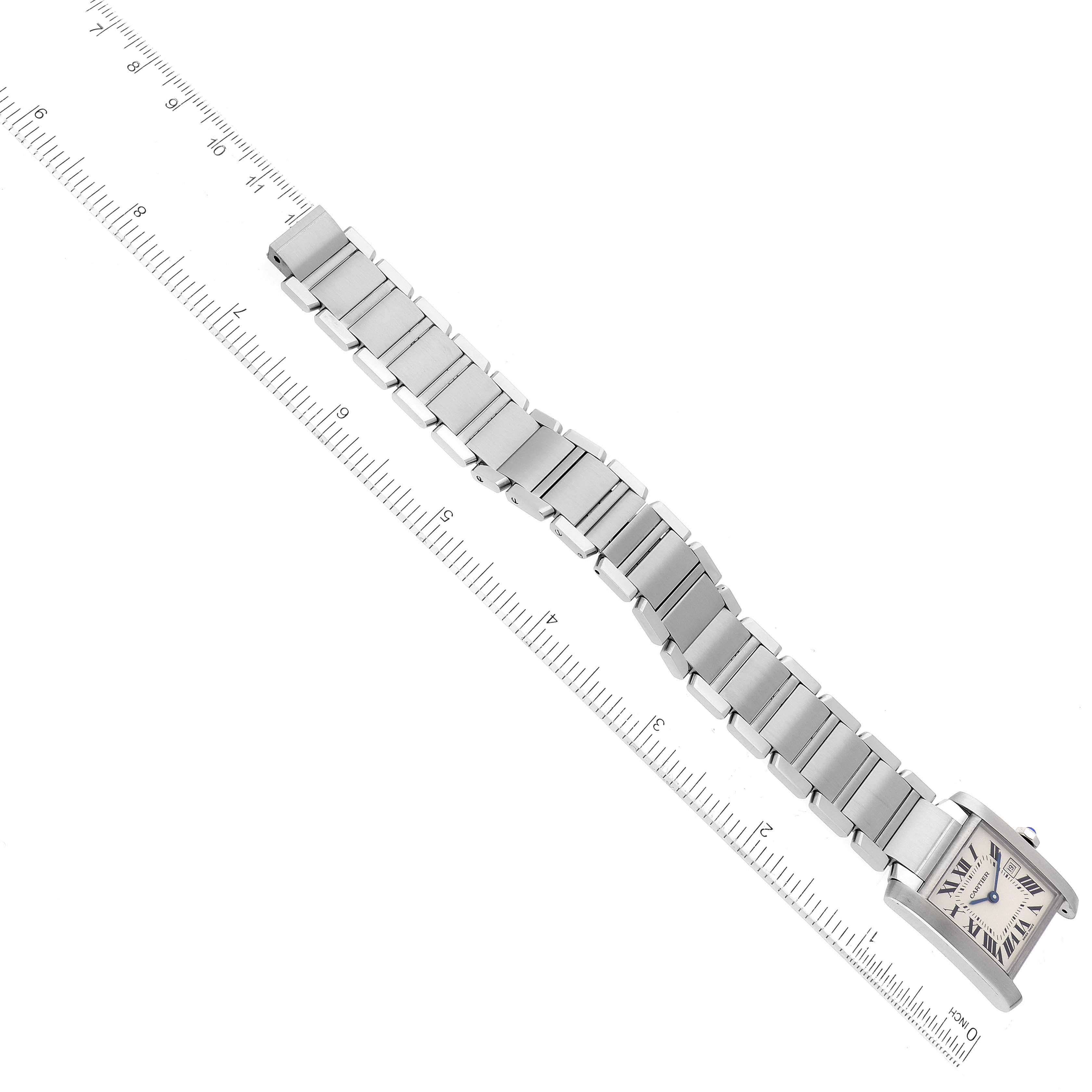 This image shows a Cartier Tank Francaise W51011Q3 Women
s Stainless Steel Silver Dial W51011Q3 Women
s Stainless Steel Silver Dial model watch placed diagonally with its metal bracelet extended and a ruler beside it.