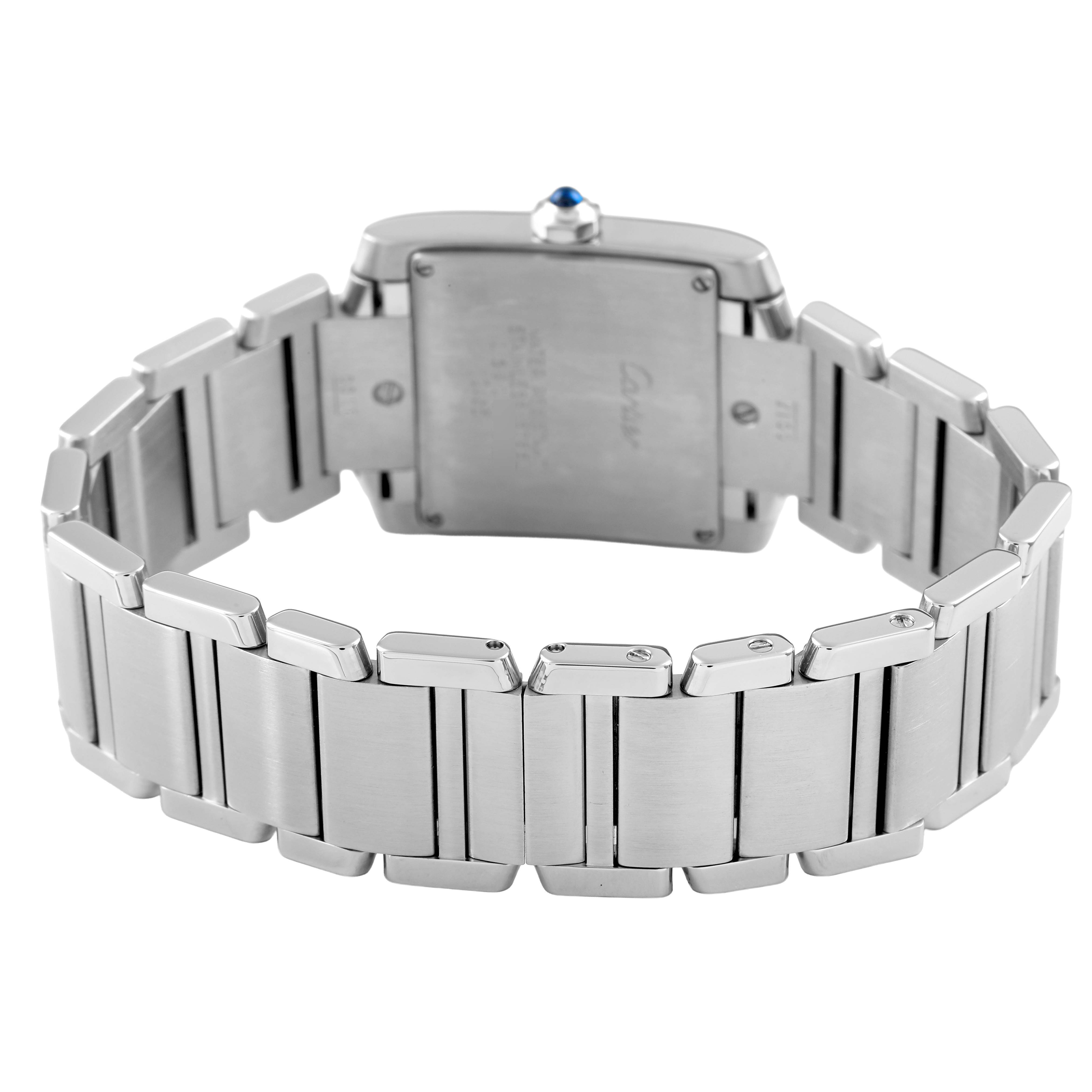 The image shows the back of a Cartier Tank Française watch, highlighting the stainless steel bracelet and case back.