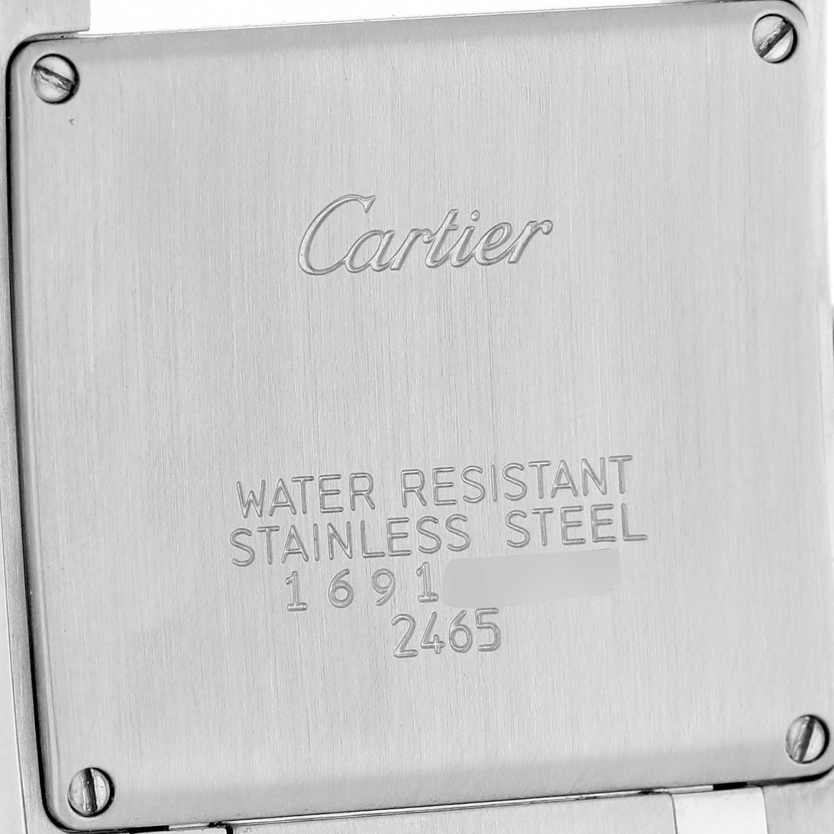 The image shows the stainless steel case back of a Cartier Tank Française watch, displaying the brand name and specifications.