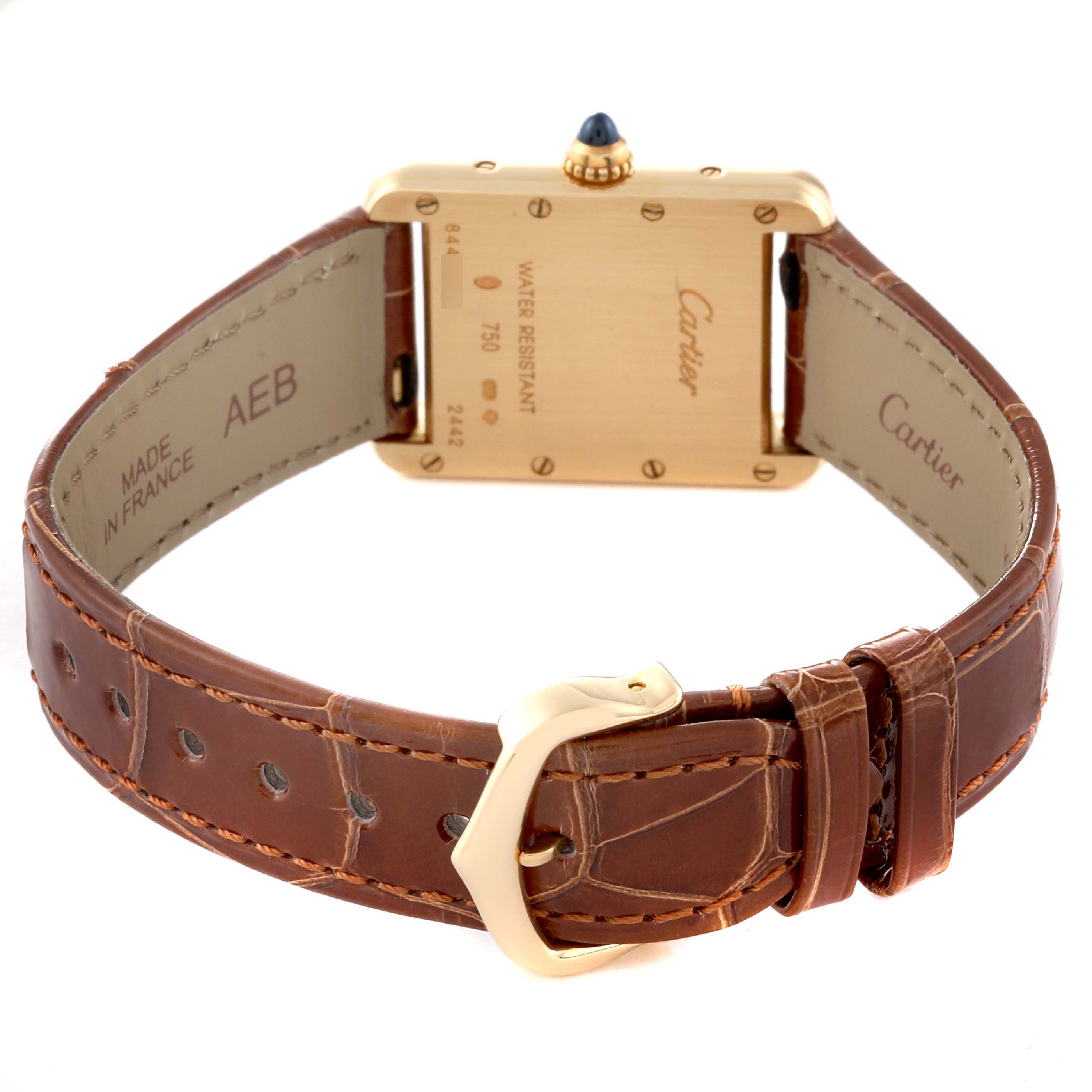 The image shows the back view of a Tank Louis model watch by Cartier, highlighting its strap, buckle, and case back details.