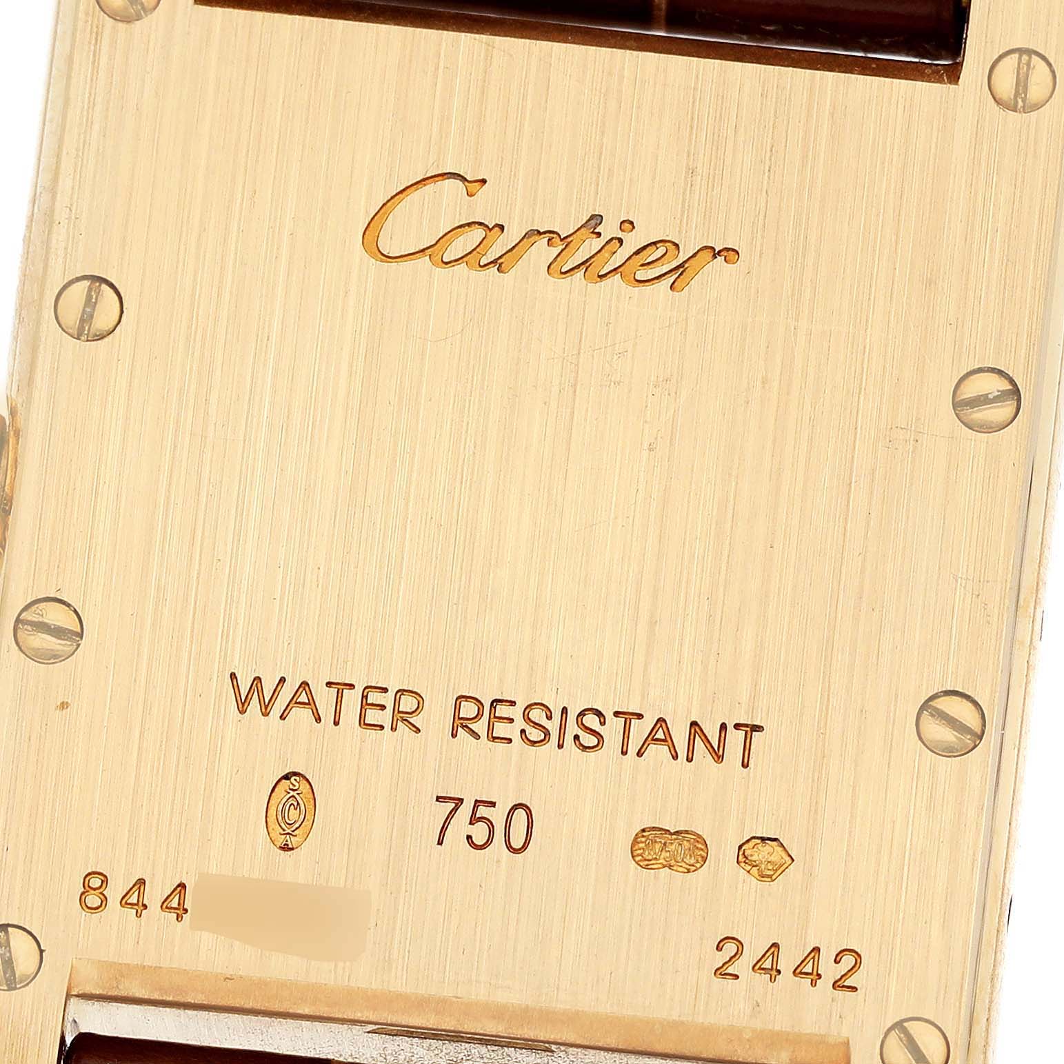 The image shows the back of a Cartier Tank Louis W1529856 Women's Yellow Gold Silver Dial W1529856 Women's Yellow Gold Silver Dial model watch, featuring engravings and hallmarks.