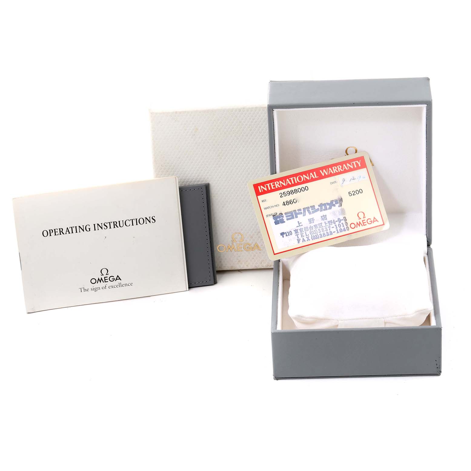 The image shows an Omega Seamaster 2598.80.00 Men's Stainless Steel Blue Dial 2598.80.00 Men's Stainless Steel Blue Dial watch's packaging, including the operating instructions, warranty card, and watch box from a front angle.