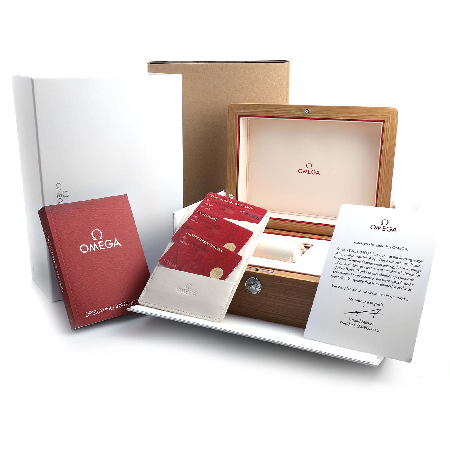 The image shows the Omega Seamaster 210.32.42.20.01.001 Men's Stainless Steel Black Dial watch packaging, warranty cards, an operating instructions booklet, and a thank you note.