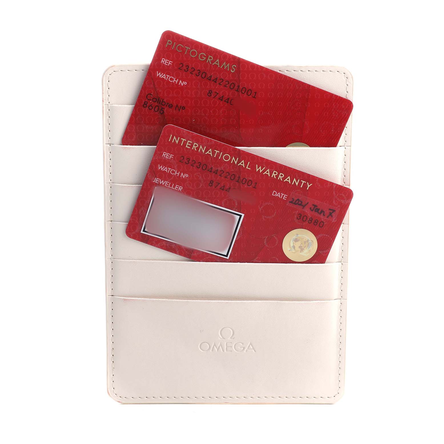 The image shows the International Warranty and Pictograms cards of an Omega Planet Ocean 232.30.44.22.01.001 Men's Stainless Steel Black Dial watch, placed in a cardholder.