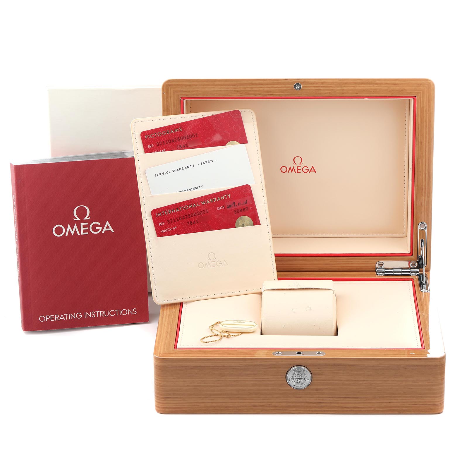 The image shows the Omega Speedmaster 321.10.42.50.01.001 Men's Stainless Steel Black Dial 321.10.42.50.01.001 Men's Stainless Steel Black Dial packaging, including a wooden box, warranty cards, and an instruction booklet.