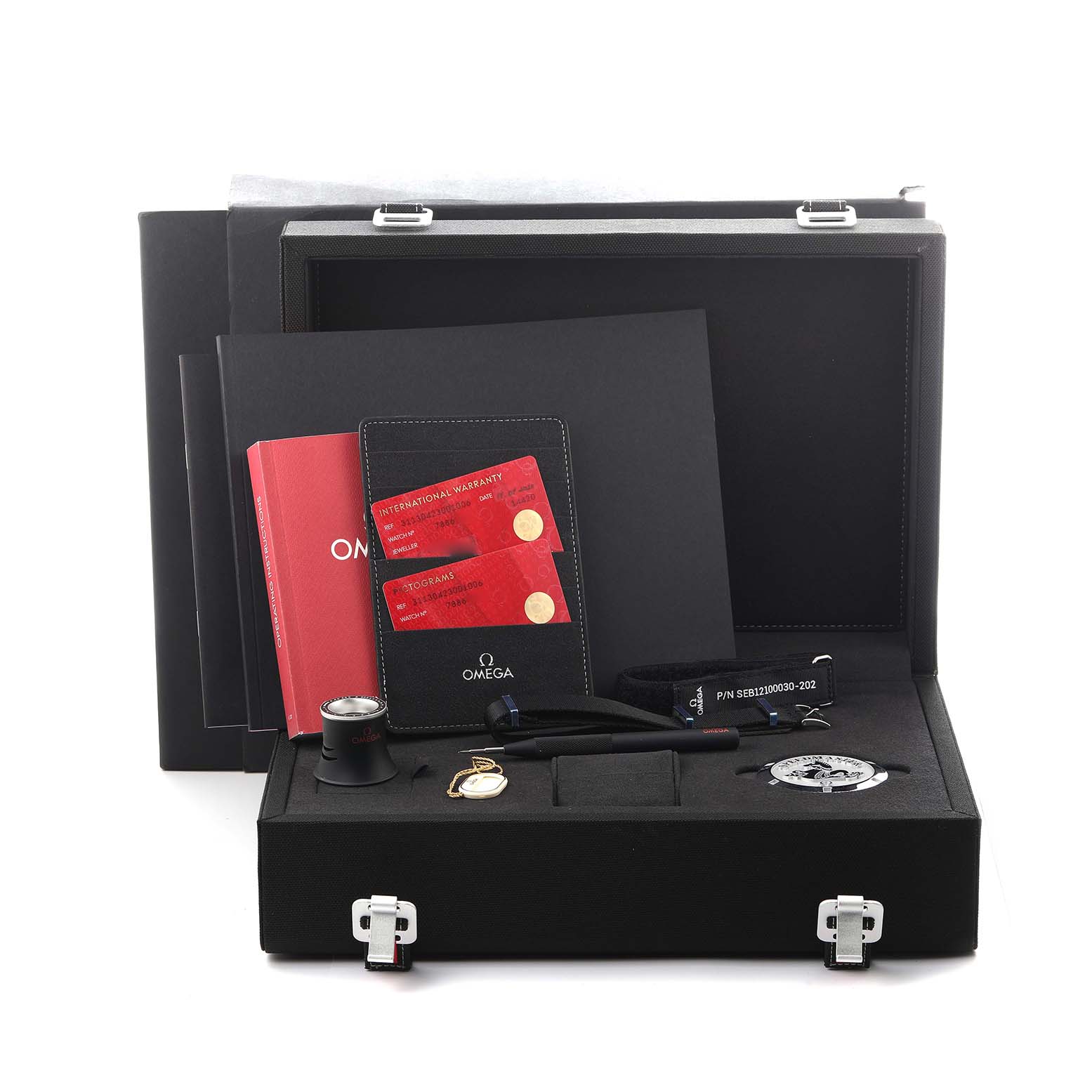 The image shows the Omega Speedmaster 311.30.42.30.01.006 Men's Stainless Steel Black Dial 311.30.42.30.01.006 Men's Stainless Steel Black Dial watch packaging, including documentation, a loupe, and accessories, from a front angle.