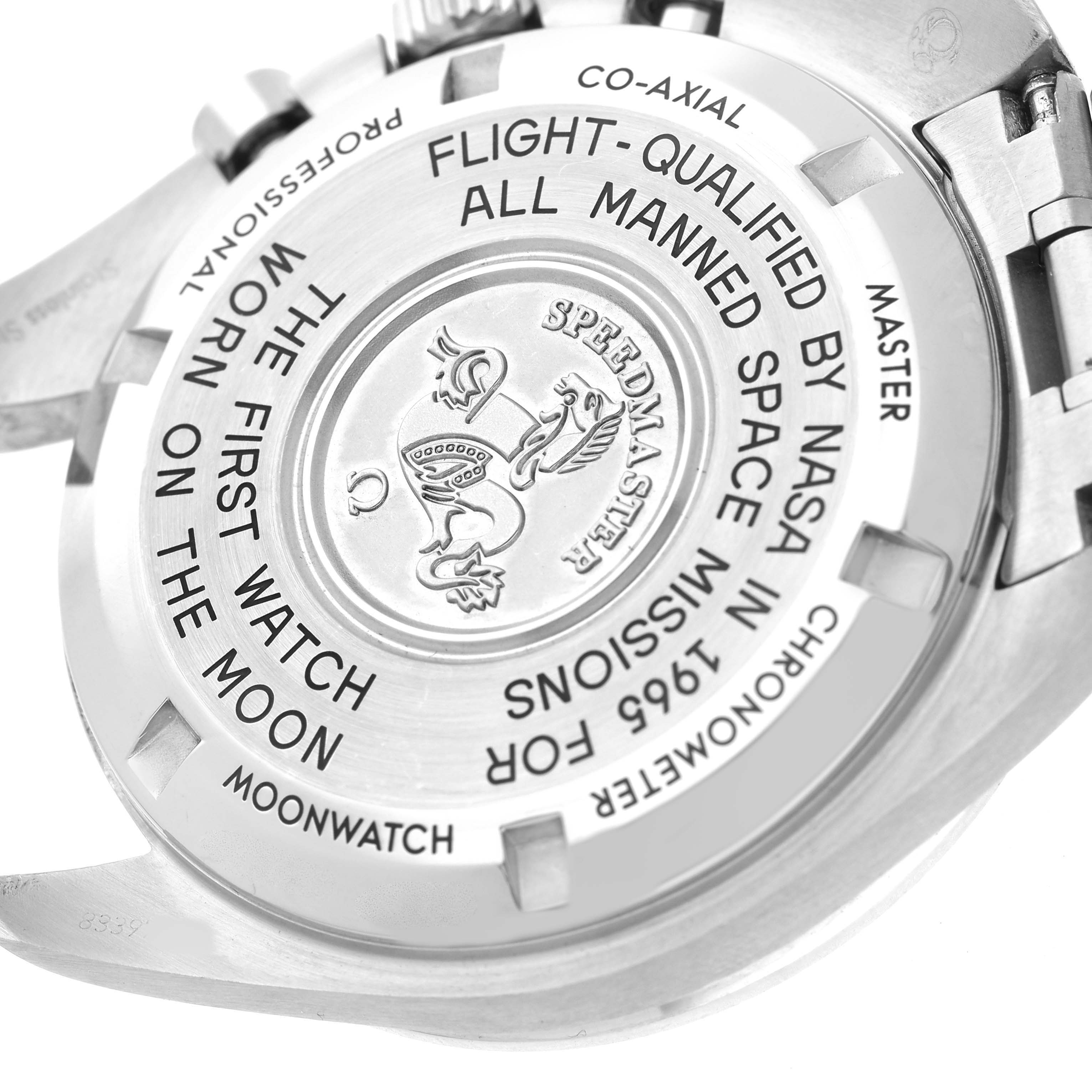 The image shows the case back of an Omega Speedmaster 310.30.42.50.01.001 Men's Stainless Steel Black Dial, highlighting its inscriptions and emblem.