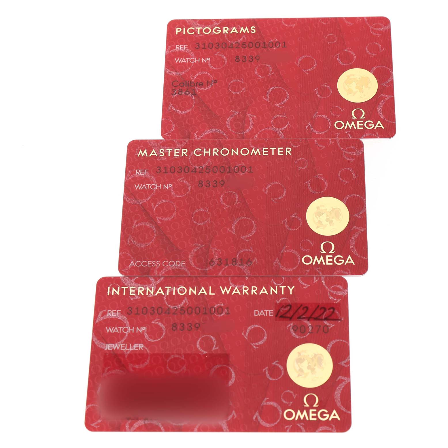 The image shows three Omega Speedmaster 310.30.42.50.01.001 Men's Stainless Steel Black Dial warranty and information cards from a top-down angle.