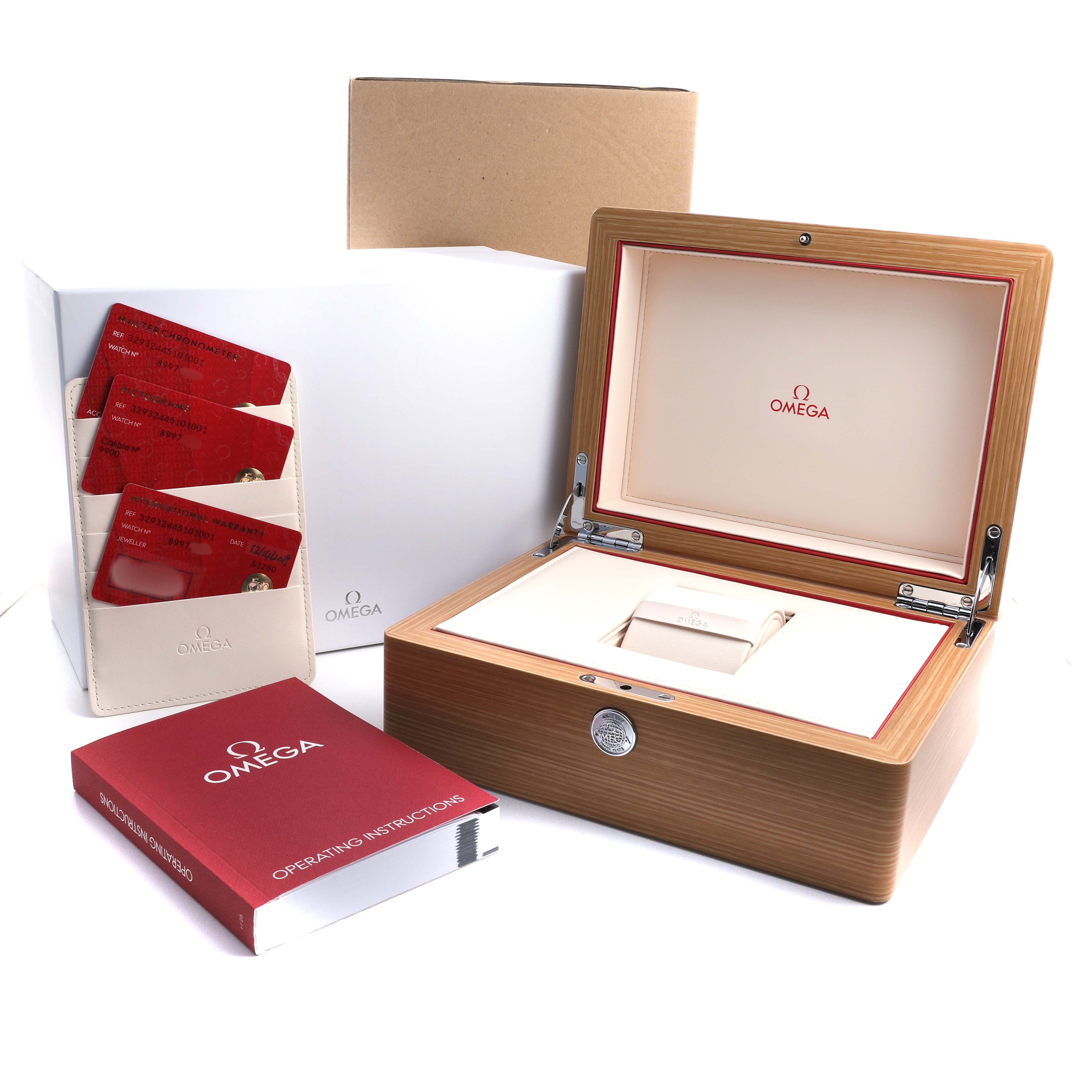 The image shows an Omega Speedmaster 329.32.44.51.01.001 Men's Stainless Steel Black Dial box, warranty cards, and an instruction manual from a frontal angle.