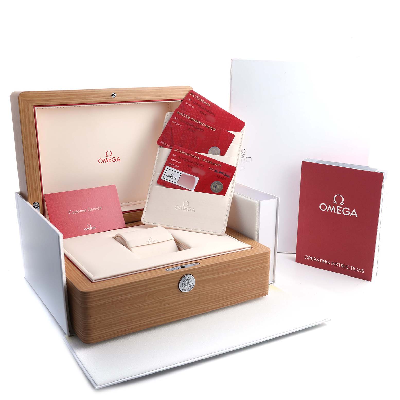 The image shows an Omega Speedmaster 329.30.44.51.04.001 Men's Stainless Steel Silver Dial watch box and accessories, including warranty cards, a manual, and a microfiber pouch.