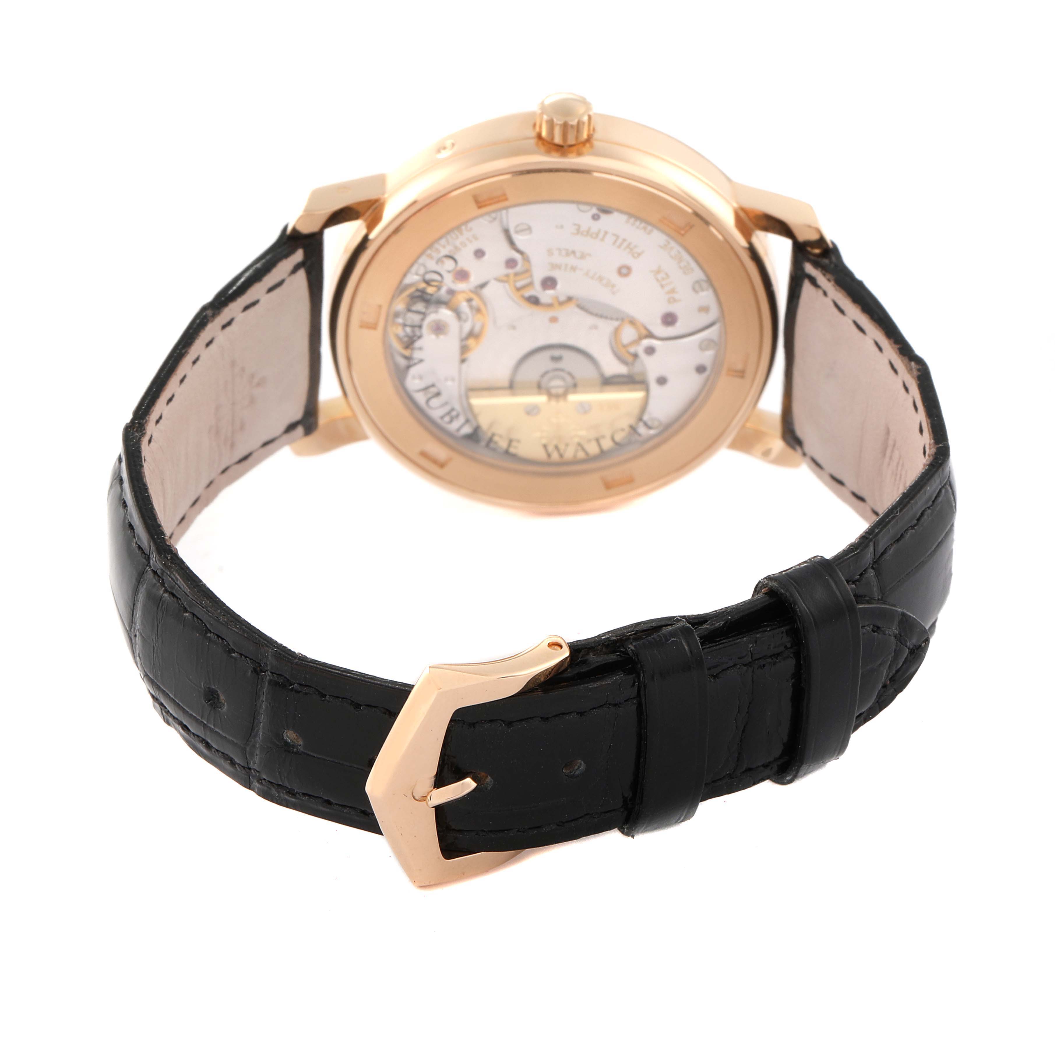 The Patek Philippe Calatrava 5057R Men's Rose Gold White Dial 5057R Men's Rose Gold White Dial watch is shown from the back, highlighting its inner mechanics and black leather strap.