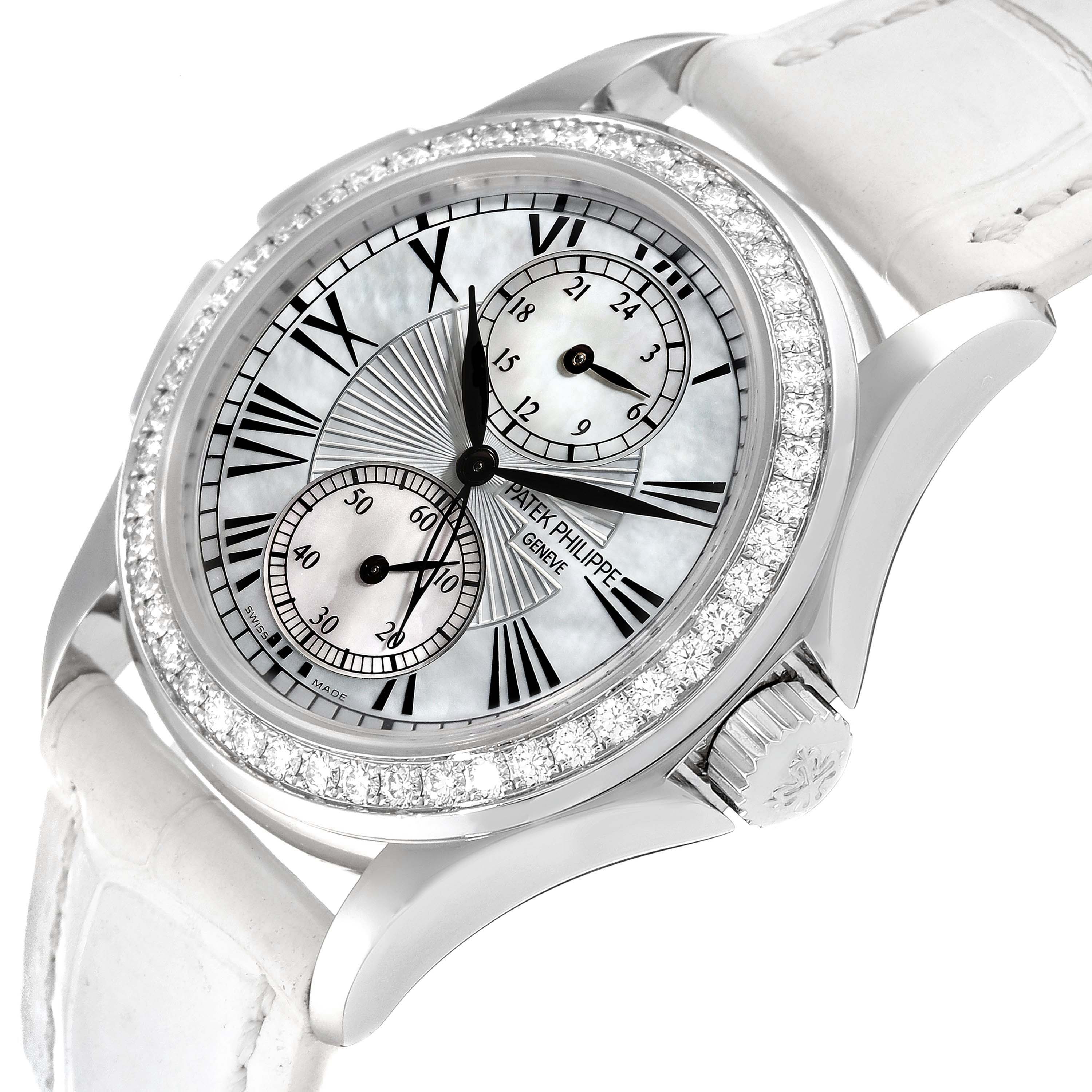 The image shows a close-up of the dial and bezel of a Patek Philippe Calatrava 4934G Women
s White Gold Mother of Pearl Dial 4934G Women
s White Gold Mother of Pearl Dial watch with a diamond-encrusted bezel and subdials.