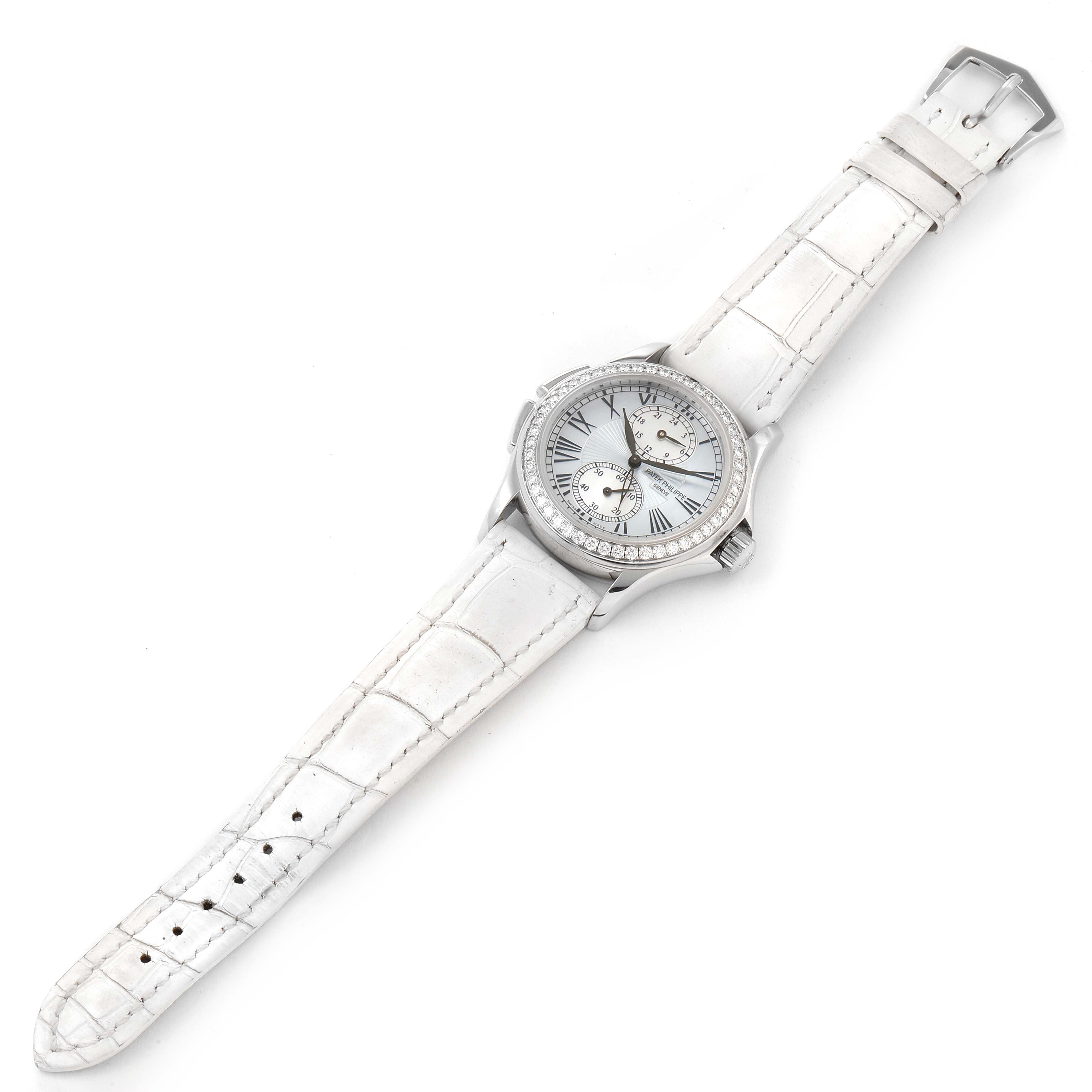 The image shows a Calatrava model by Patek Philippe from a top view, revealing its face, bezel, and white leather strap.