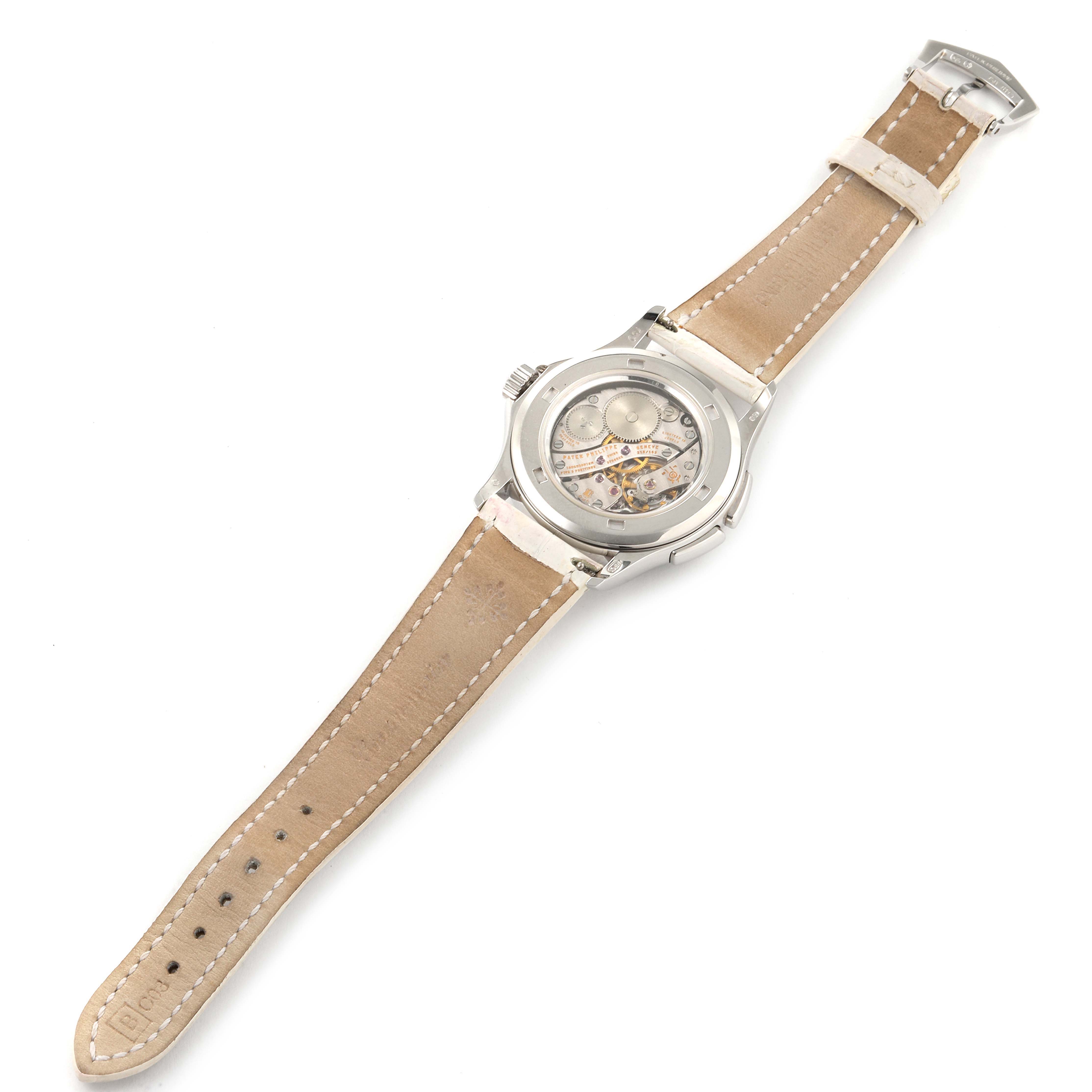 The image shows the back view of a Patek Philippe Calatrava 4934G Women
s White Gold Mother of Pearl Dial 4934G Women
s White Gold Mother of Pearl Dial watch, displaying its movement and leather strap.