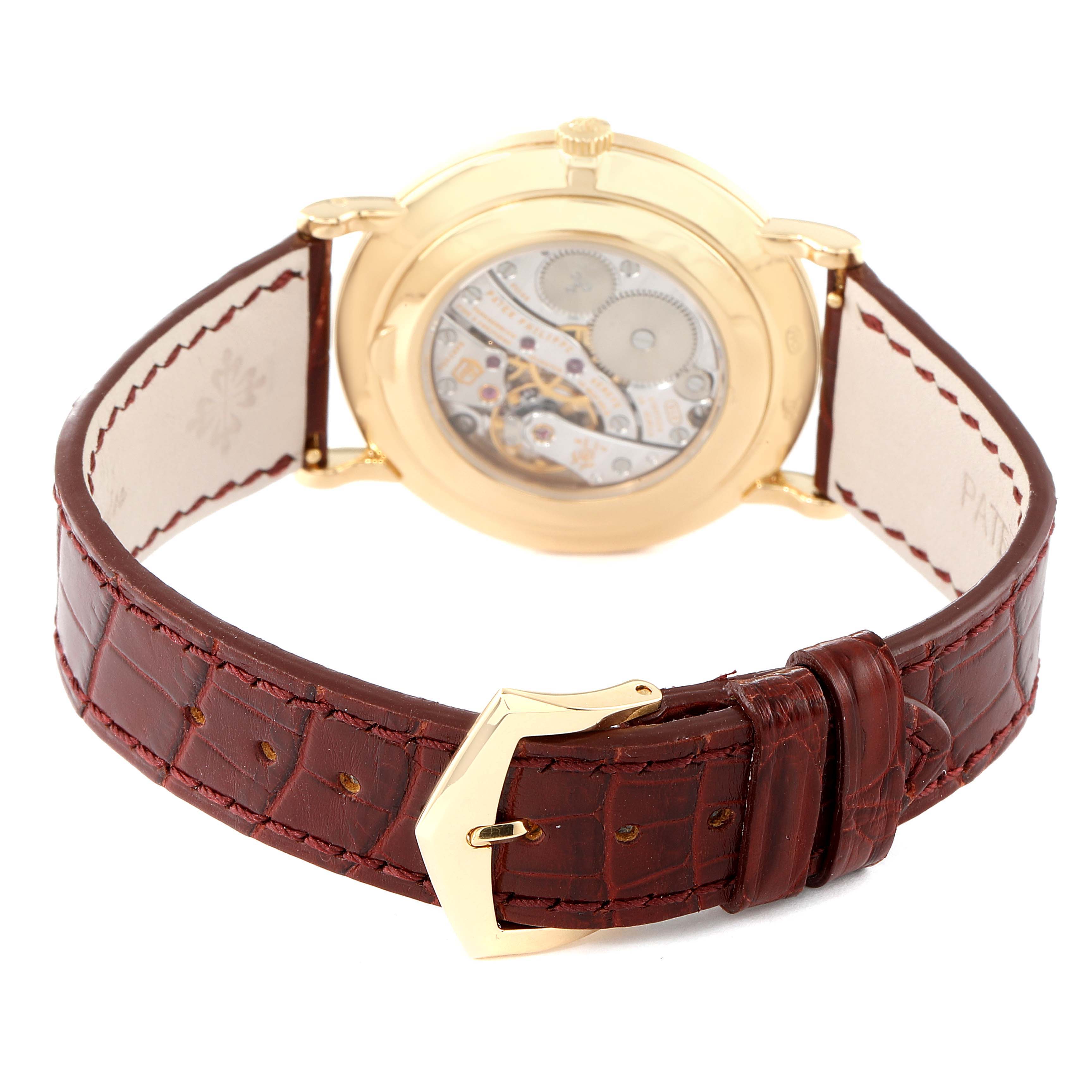 The image shows the back view of a Patek Philippe Calatrava 5119J Men's Yellow Gold White Dial 5119J Men's Yellow Gold White Dial watch, highlighting its leather strap and transparent case back.