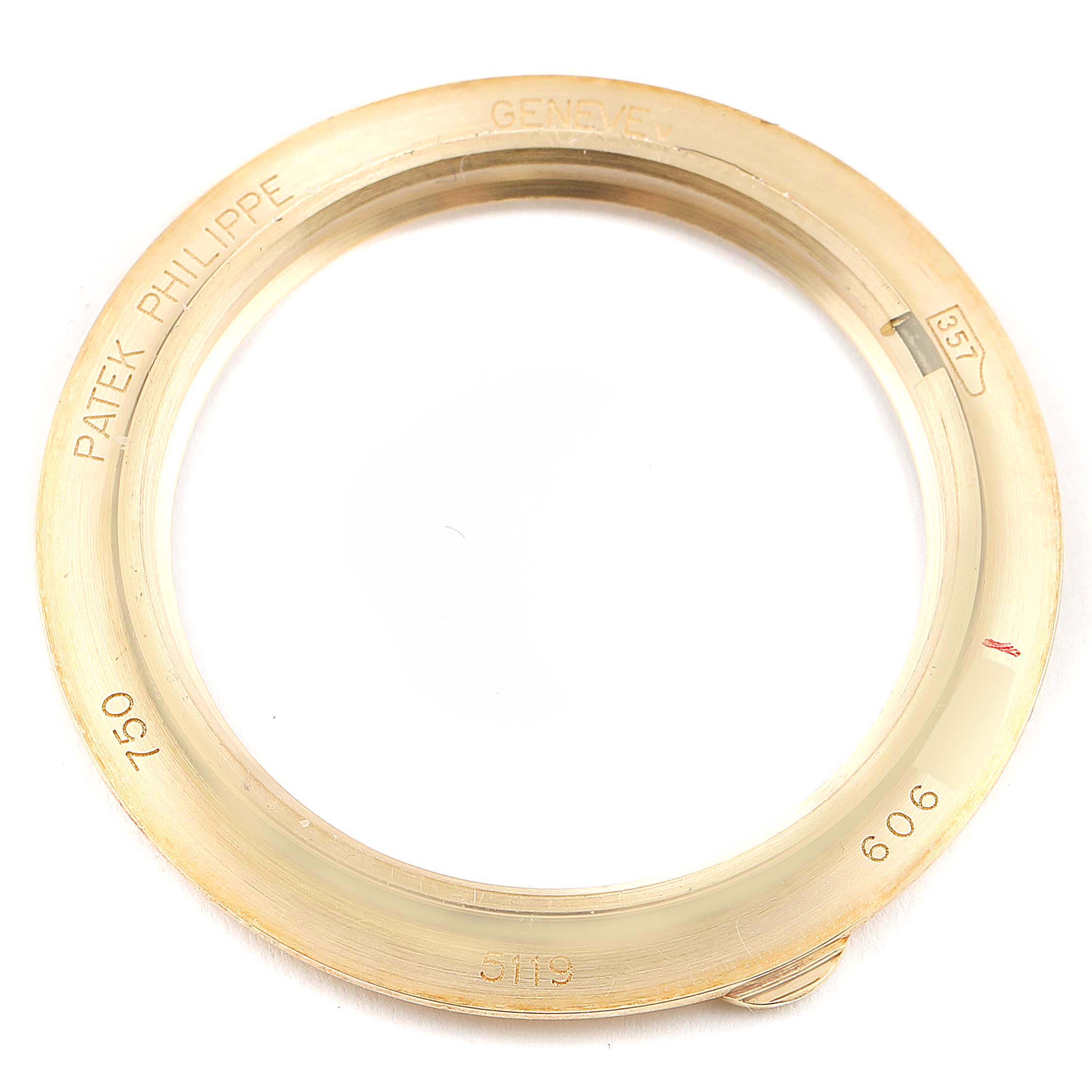 The image shows the metal ring of the Patek Philippe Calatrava 5119J Men's Yellow Gold White Dial 5119J Men's Yellow Gold White Dial model watch taken from a top-down angle.