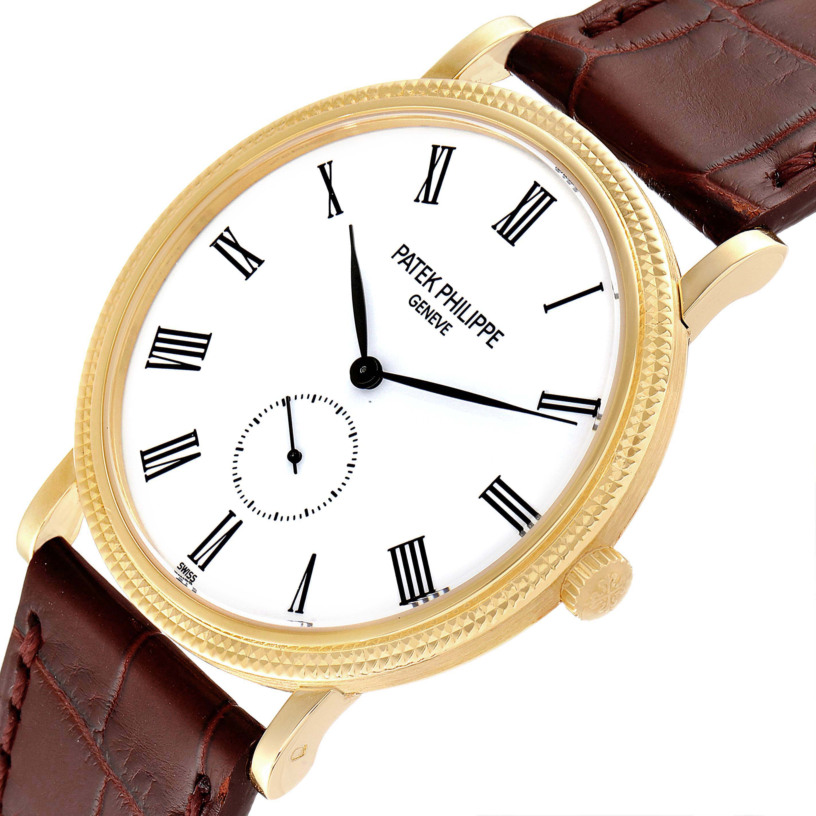 This image shows a close-up view of the Patek Philippe Calatrava 5119J Men's Yellow Gold White Dial 5119J Men's Yellow Gold White Dial watch, highlighting its dial, crown, and part of the leather strap.