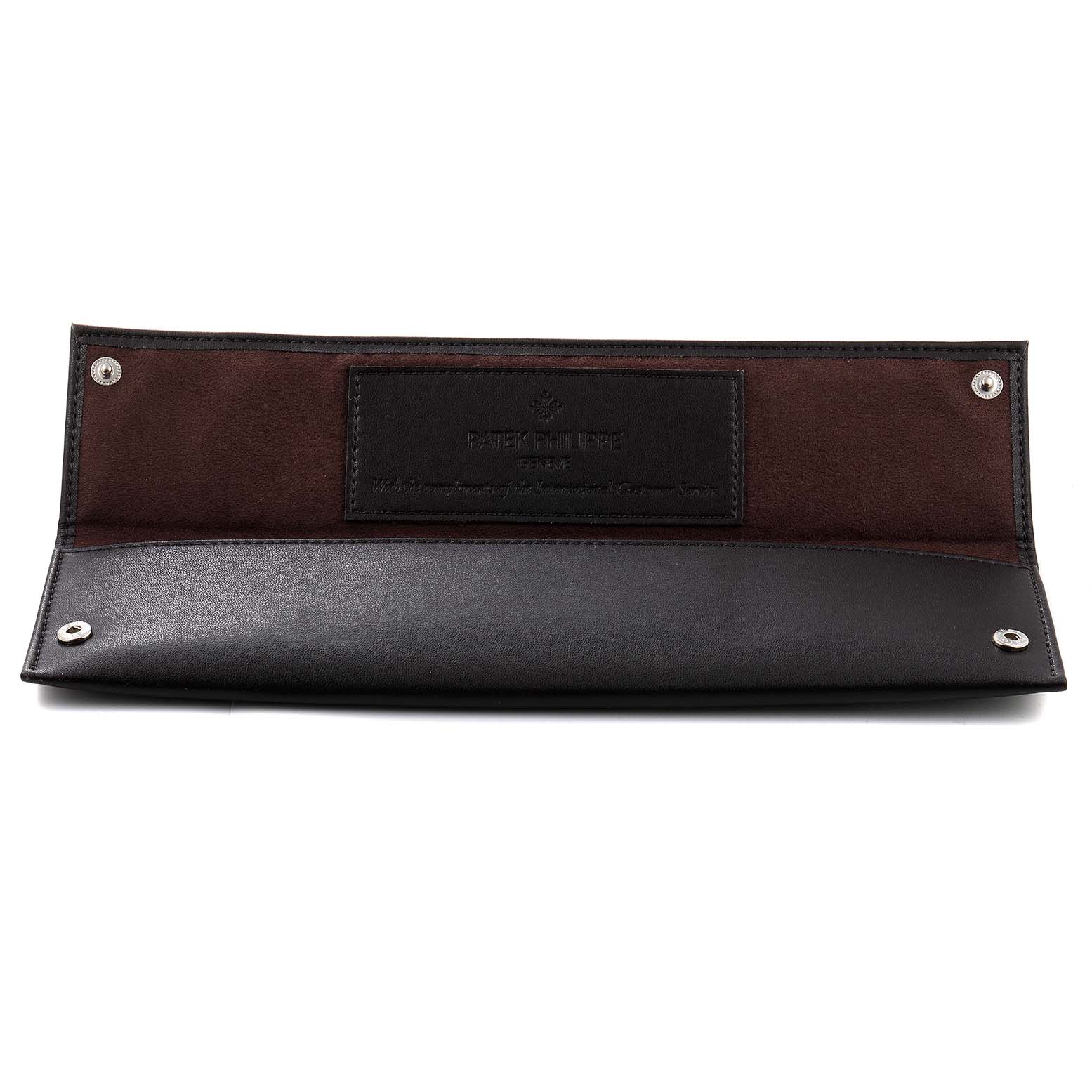 This image shows an open black and brown leather pouch for Patek Philippe's Calatrava model.