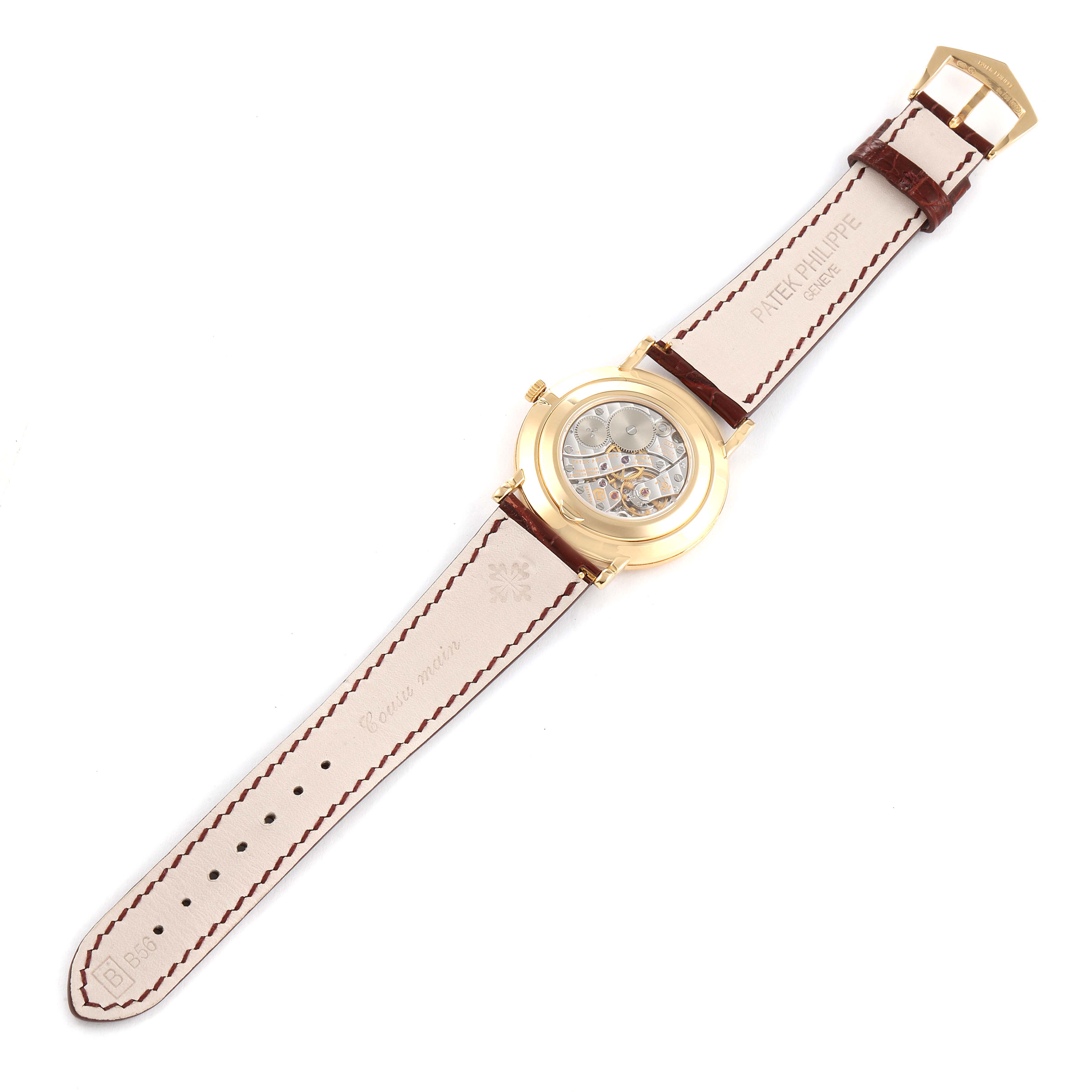 This image shows the back view of a Patek Philippe Calatrava 5119J Men's Yellow Gold White Dial 5119J Men's Yellow Gold White Dial watch, displaying the transparent case back, leather strap, and buckle.