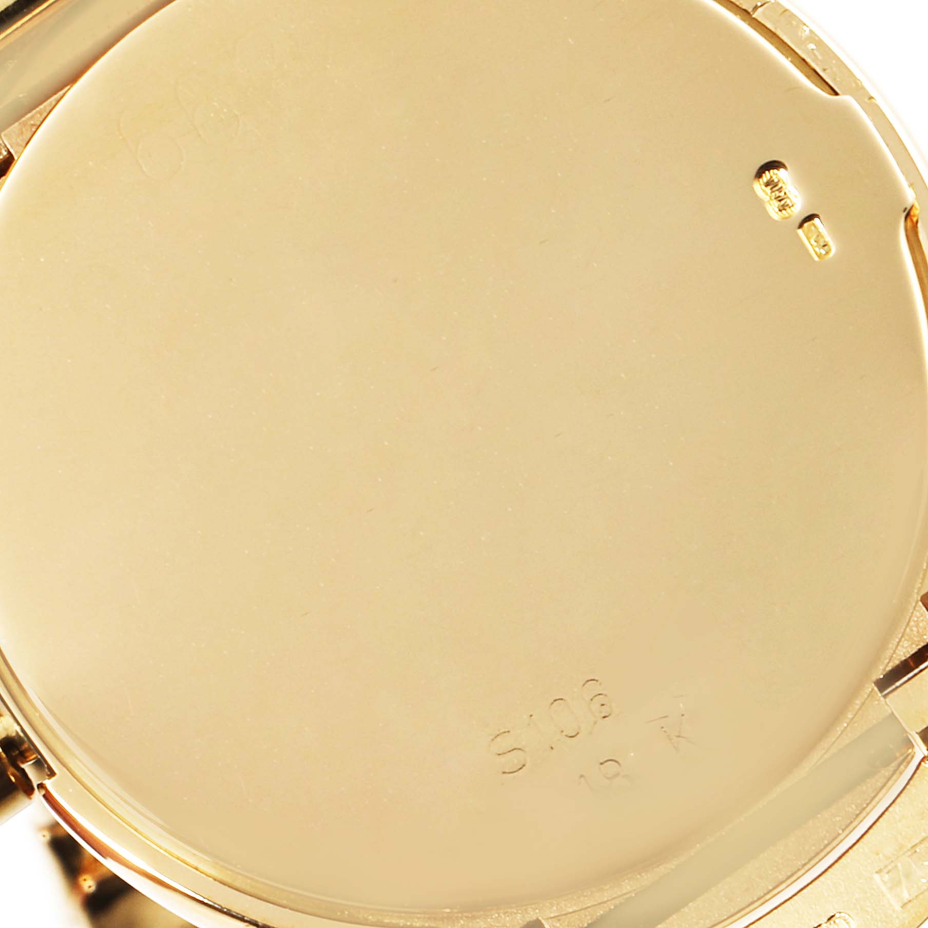 This close-up image shows the back case of a Rolex Cellini 6622 Men's Yellow Gold Champagne Dial 6622 Men's Yellow Gold Champagne Dial watch, highlighting its gold material and markings.