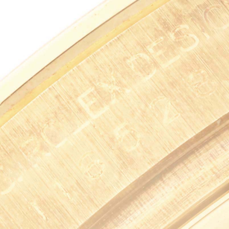 The image shows a close-up angle of the engraved inner case of a Rolex Daytona 116528 Men's Yellow Gold Black Dial 116528 Men's Yellow Gold Black Dial watch.