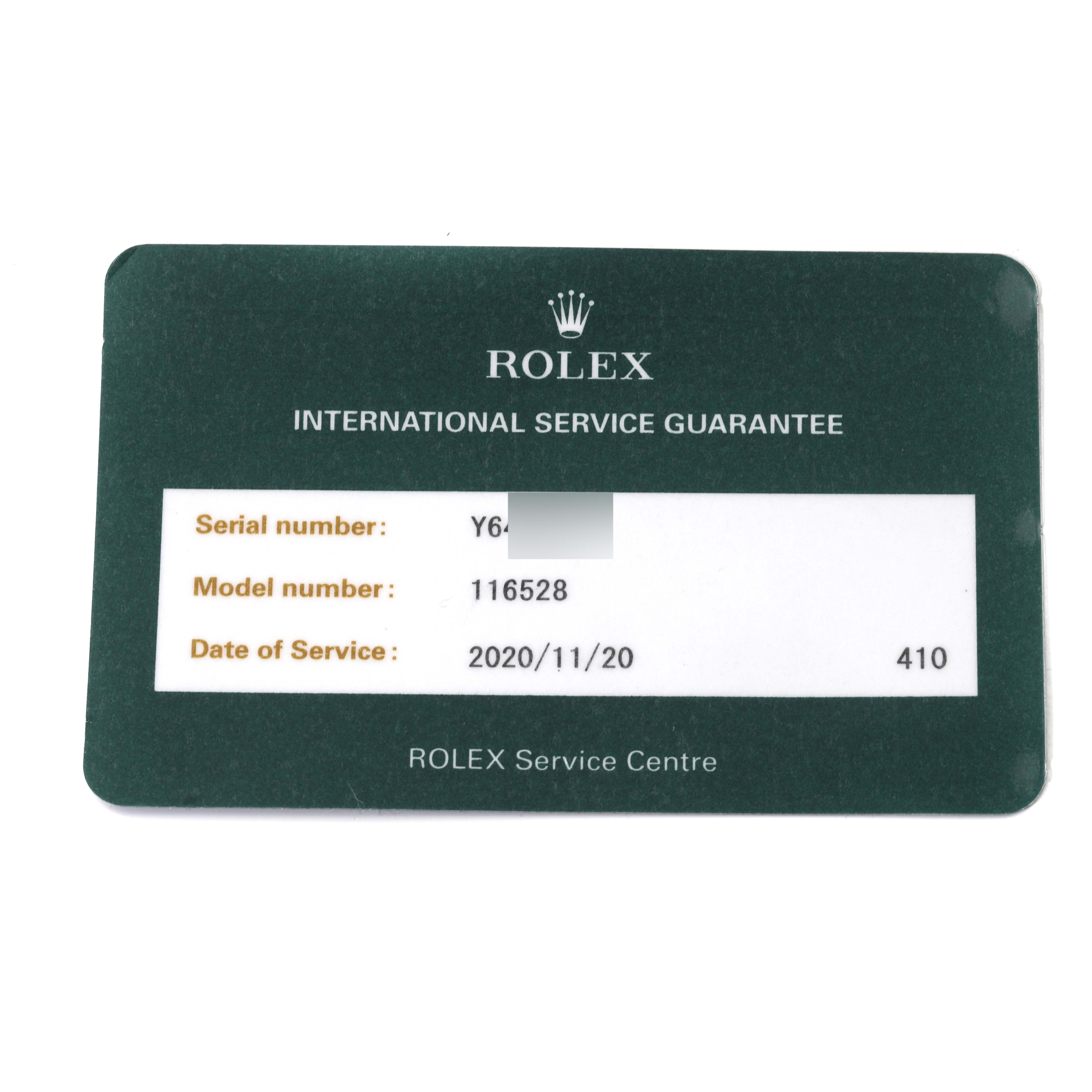 This image shows a Rolex international service guarantee card for a Daytona model 116528, including the serial number and date of service.