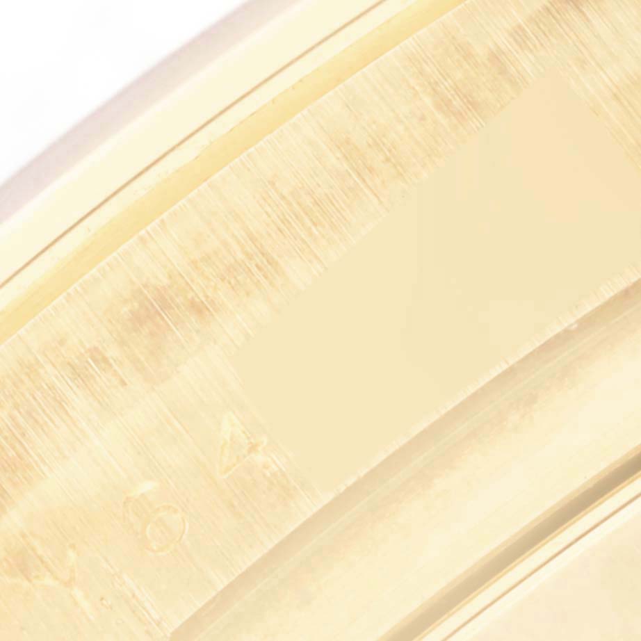 The image shows a close-up of the engraved inner bezel or rehaut of a Rolex Daytona 116528 Men's Yellow Gold Black Dial 116528 Men's Yellow Gold Black Dial watch.