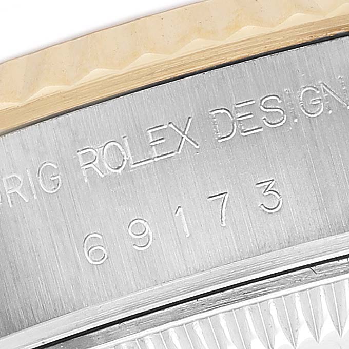The image shows a close-up of the Rolex Datejust 69173 Women's Steel and Gold (two tone) Champagne Dial model, focusing on the engraved reference number and "ROLEX DESIGN" text on the side.