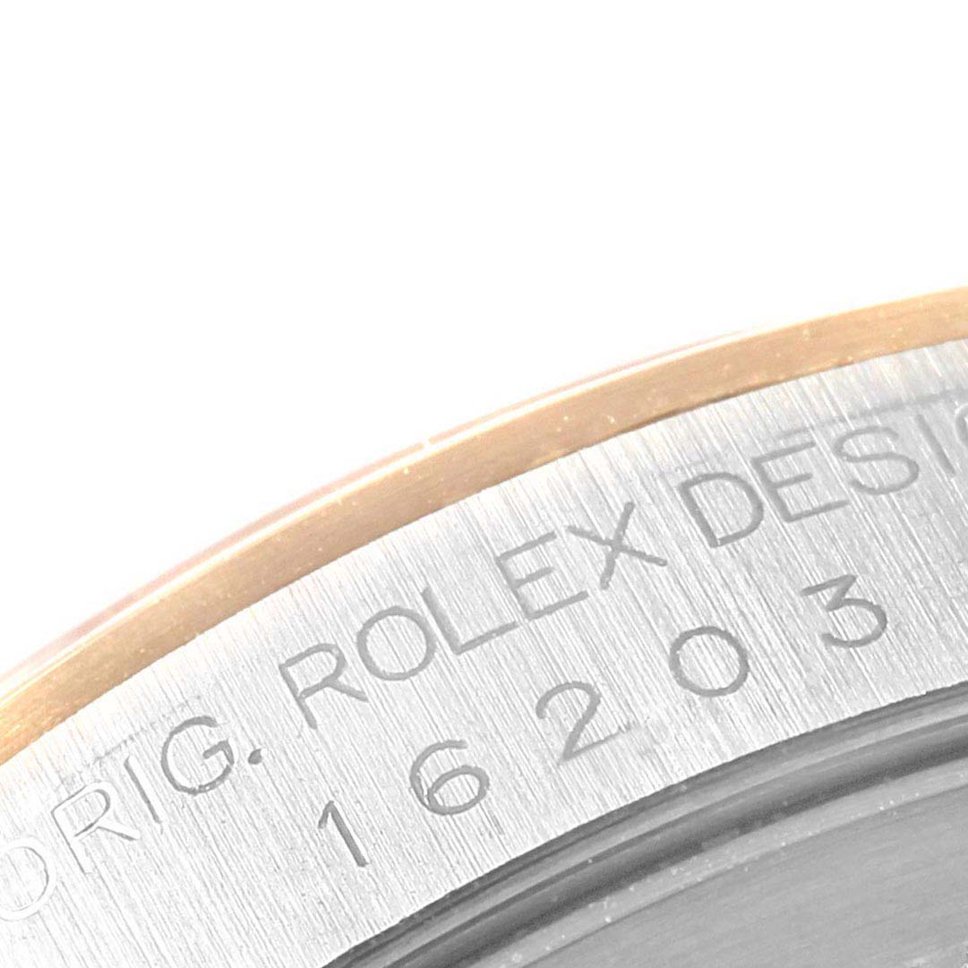 A close-up of the Rolex Datejust 16203 Men's Steel and Gold (two tone) Grey Dial 16203 Men's Steel and Gold (two tone) Grey Dial watch bezel showing the engraved model number "16203" and part of the brand name.