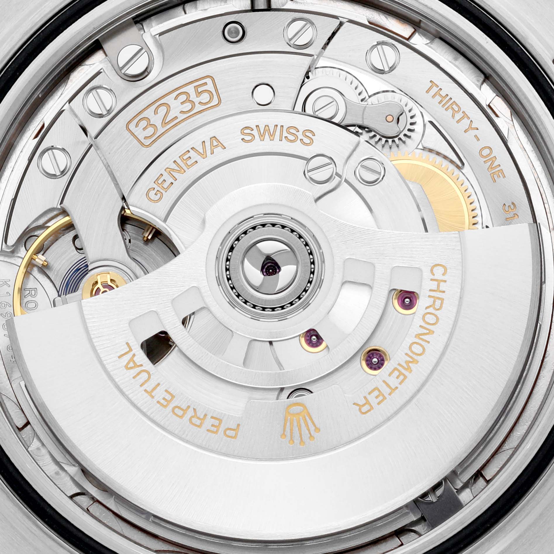 The image shows a close-up view of the movement inside a Rolex Datejust 41 126301 Men
s Steel and Gold (two tone) Pink Dial 126301 Men
s Steel and Gold (two tone) Pink Dial watch, highlighting the intricate inner mechanics and markings.