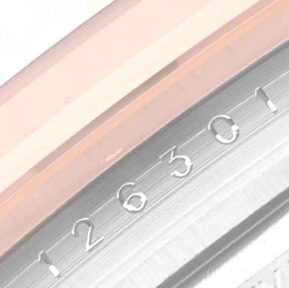 This close-up shows the side view of the bezel and part of the dial with the serial or model number of the Rolex Datejust 41 126301 Men
s Steel and Gold (two tone) Pink Dial 126301 Men
s Steel and Gold (two tone) Pink Dial.