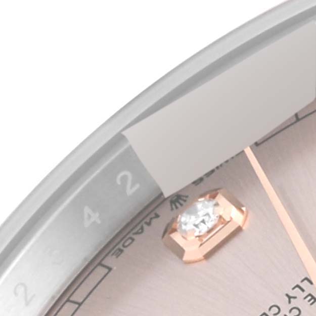 The image shows a close-up of the dial and diamond marker of a Rolex Datejust 41 126301 Men
s Steel and Gold (two tone) Pink Dial 126301 Men
s Steel and Gold (two tone) Pink Dial, with part of the bezel visible.