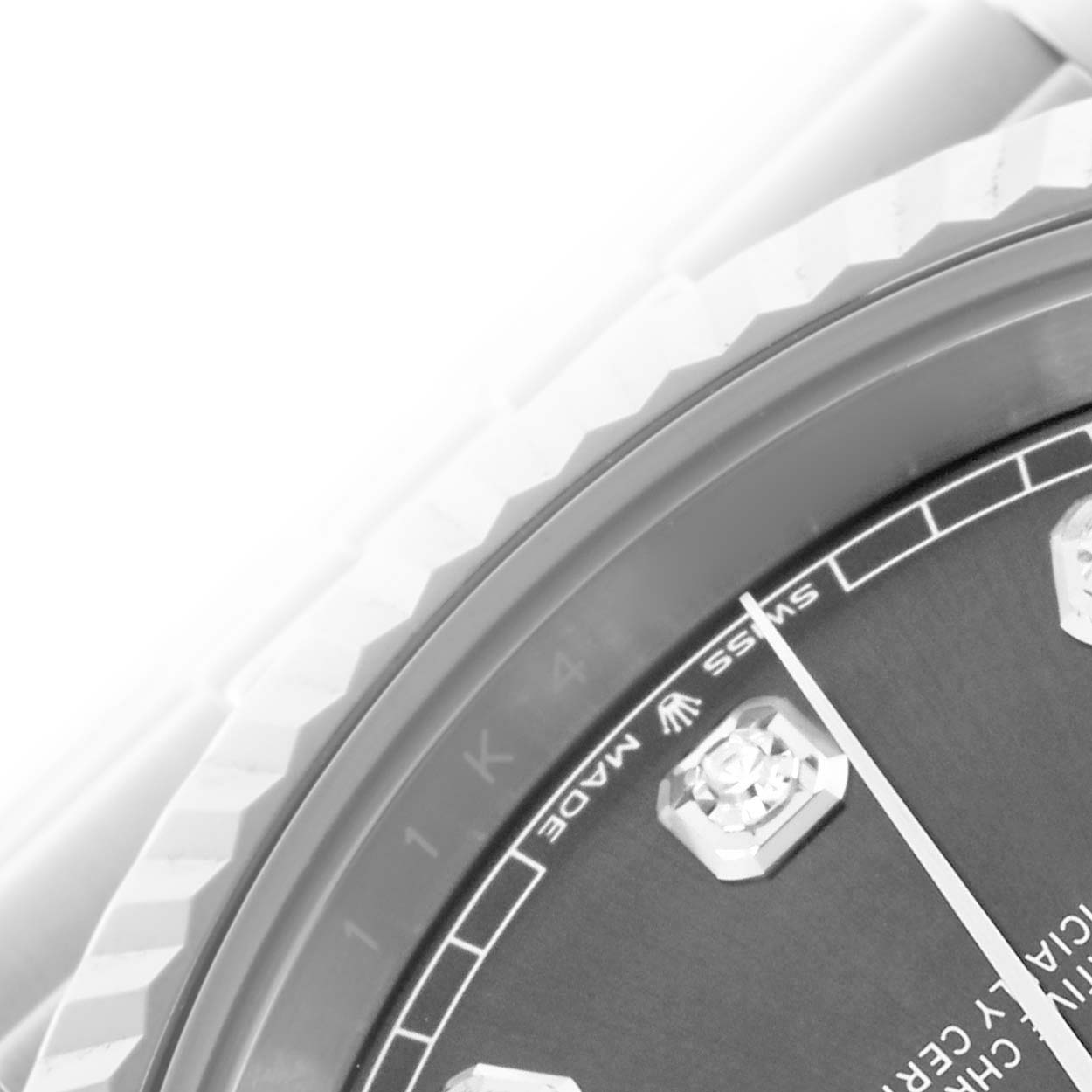 The image shows a close-up of the Rolex Datejust 41 126334 Men's Stainless Steel Grey Dial 126334 Men's Stainless Steel Grey Dial's dial and bezel, highlighting the hour markers and part of the fluted bezel.