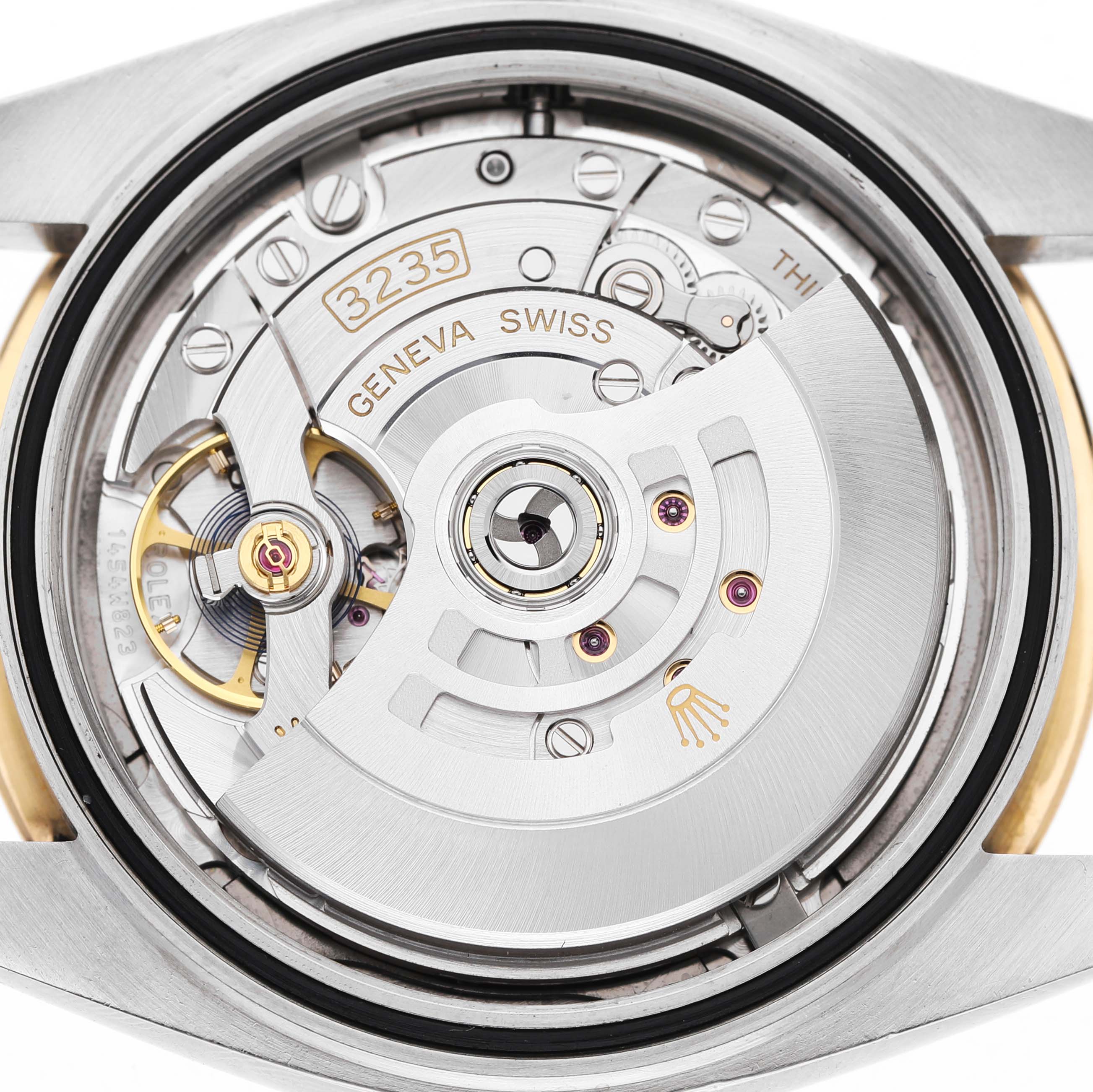The image shows a close-up of the Rolex Datejust 41 126333 Men's Steel and Gold (two tone) Grey Dial movement from the back, highlighting the gears, rotor, and "3235" engraving.