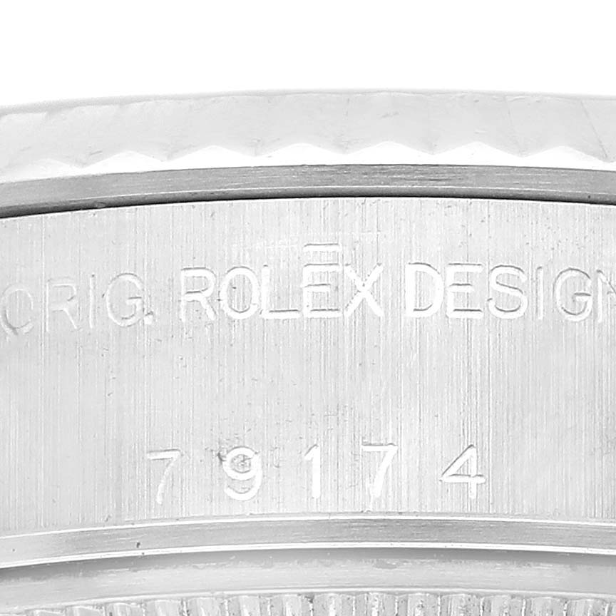 The image shows a close-up of the serial number and "Rolex Design" inscription on the side of a Rolex Datejust 79174 Women's Stainless Steel Black Dial 79174 Women's Stainless Steel Black Dial case.