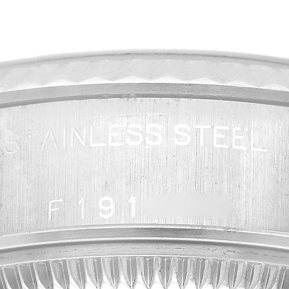 This Rolex Datejust 79174 Women's Stainless Steel Black Dial 79174 Women's Stainless Steel Black Dial watch image shows an up-close angle of the outer rim and the serial number engraving.